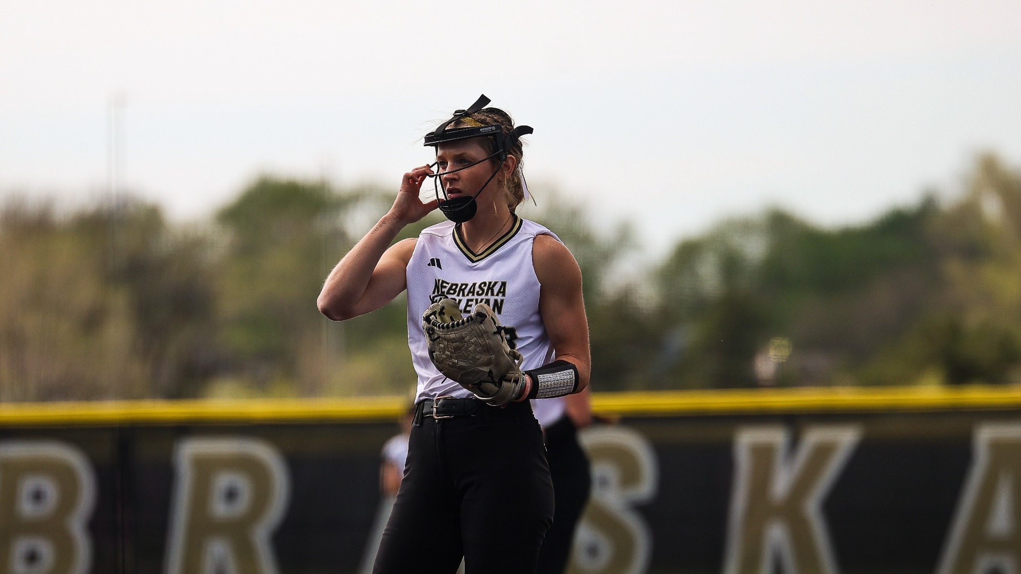 Eva Fahrnbruch adjusts her pitchers mask