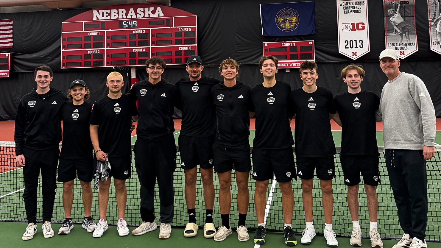 Men's Tennis Team Poses in Front of the Nebraska Scoreboard at Sid and Hazel Dillon Tennis Center