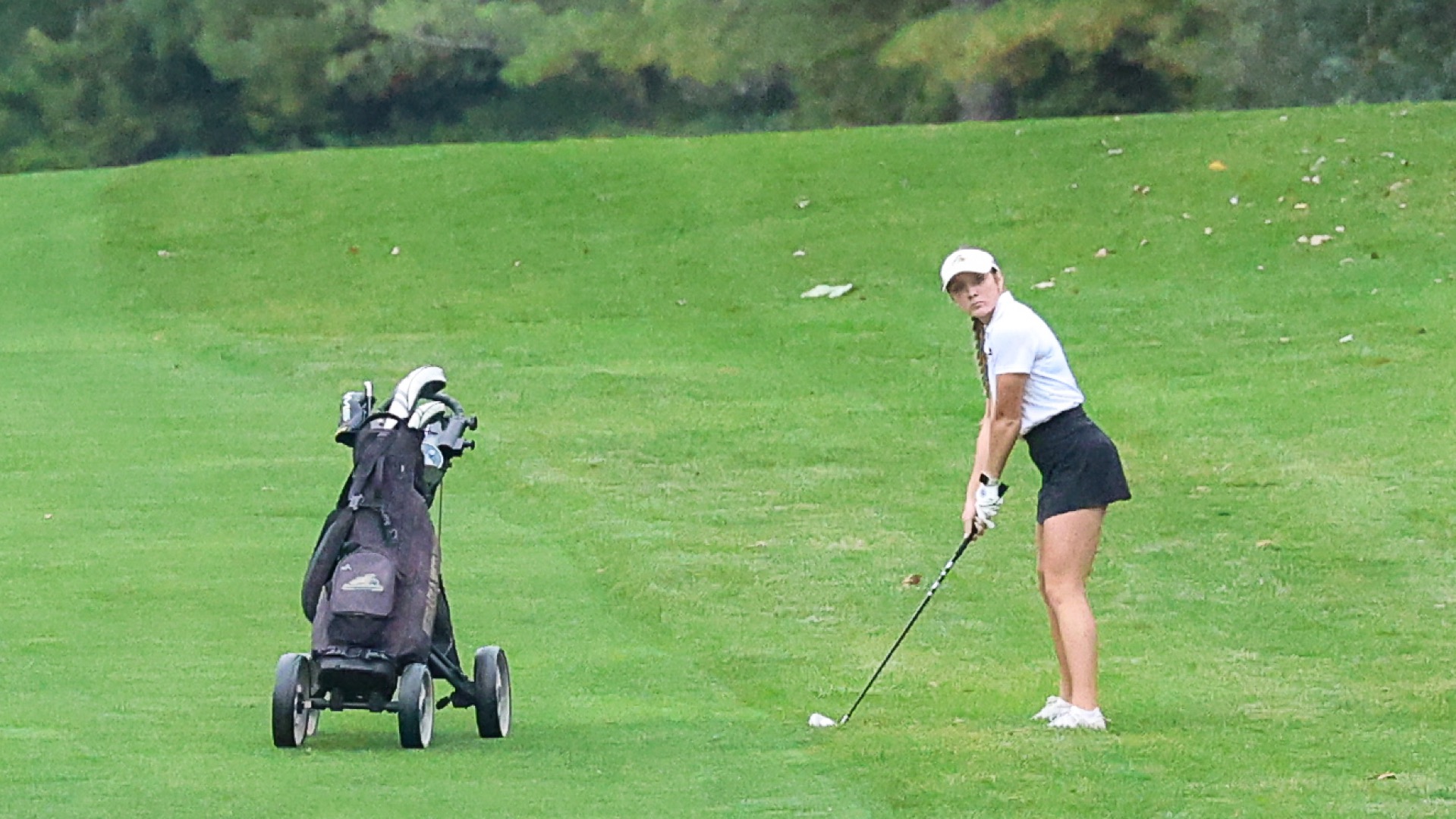 Haley Blackstone lines up and stares at the shot she is about to hit in the fairway