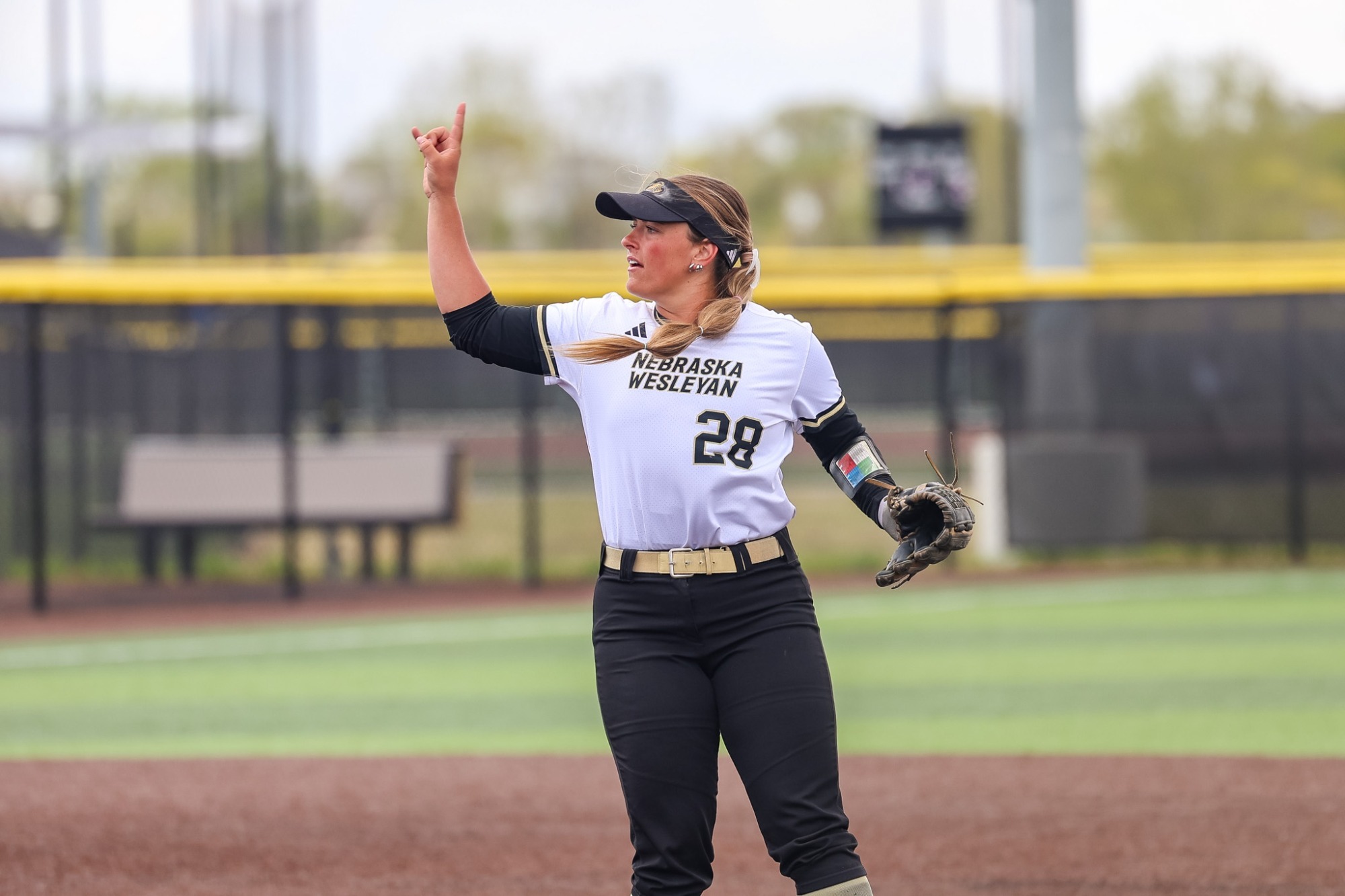 Jenna Kimberling signals the number of outs against Dubuque