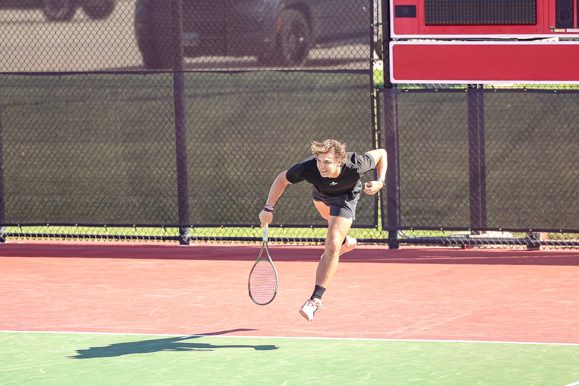 Gavin Nichols serves against Wartburg