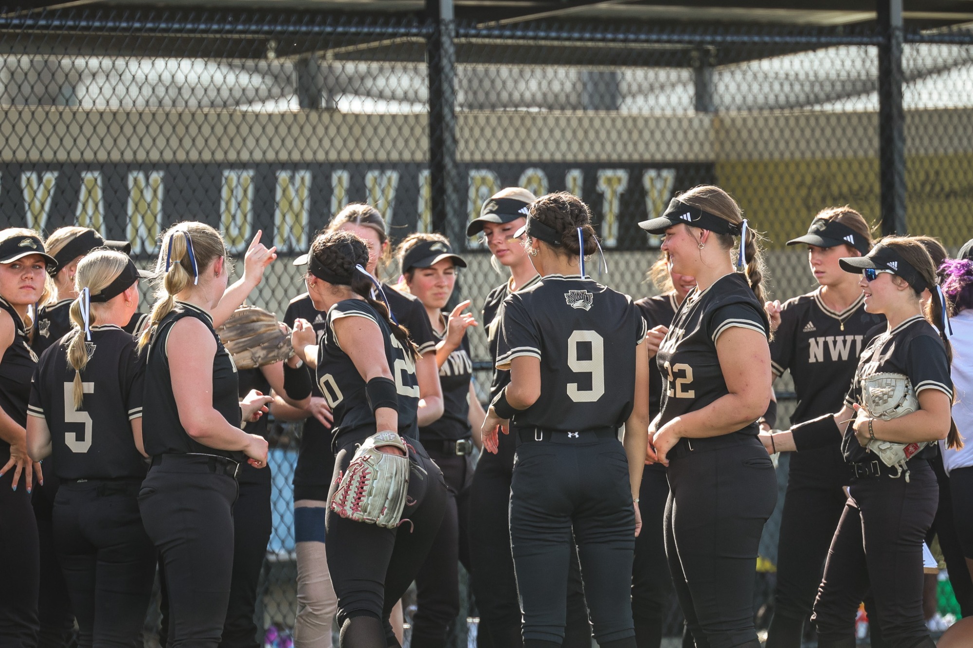 Nebraska Wesleyan has a team breakdown before an inning against Concordia