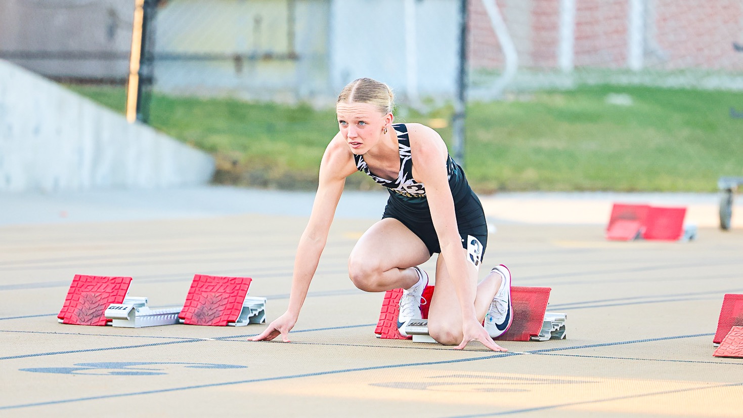 Jadah Laughlin sits in her blocks awaiting the gun in the 100 meter dash