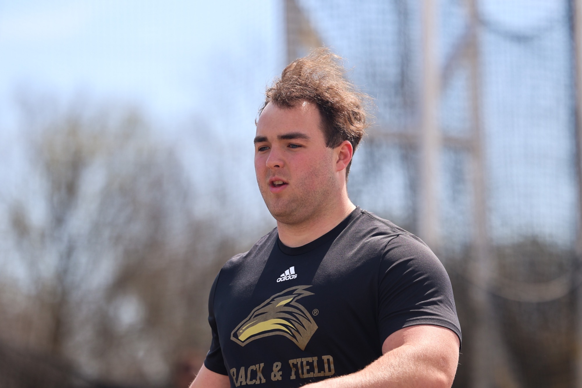Sam Clements walks back to retrieve his shot put