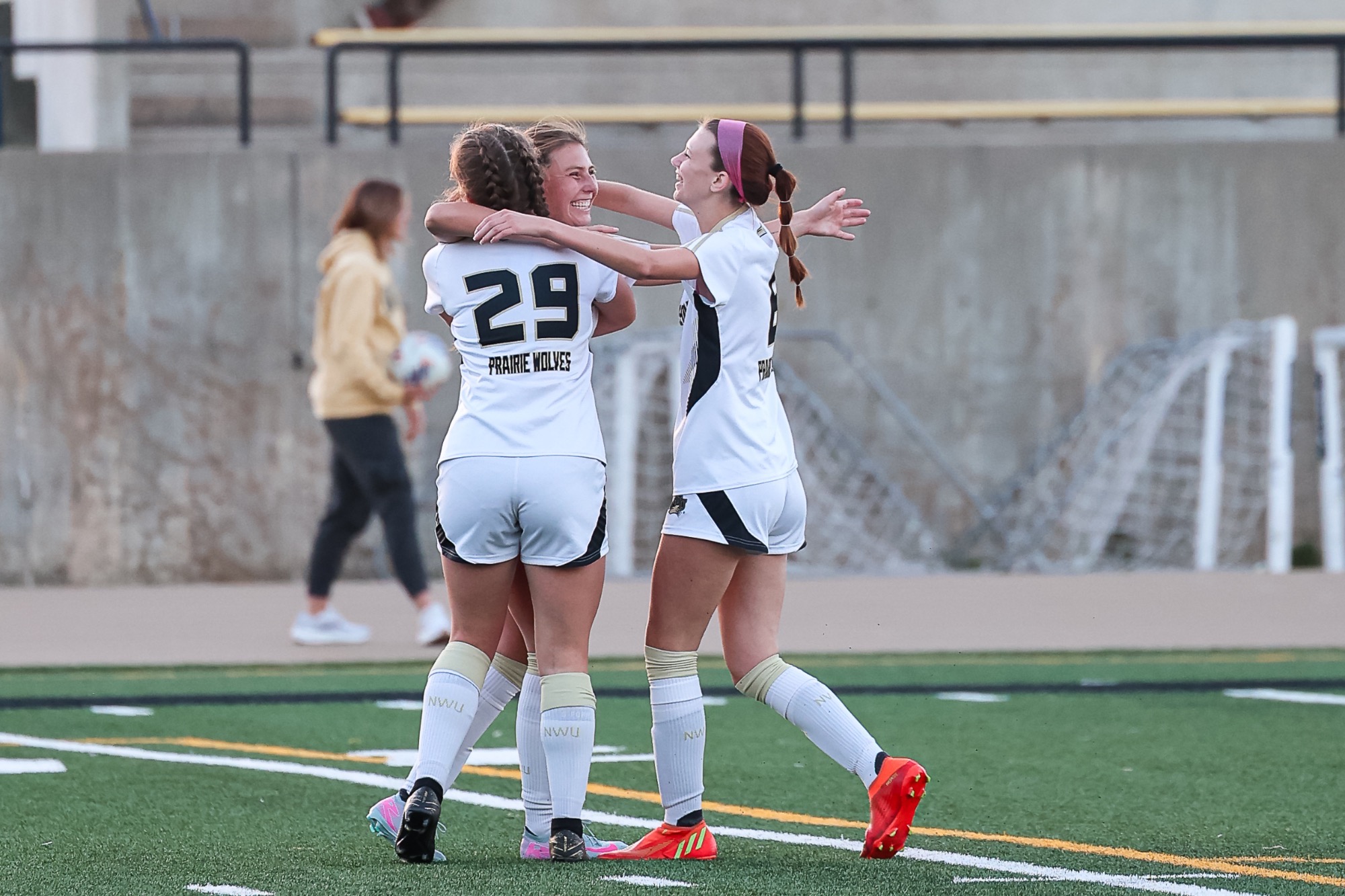 Faith Forehand and Cierra Whitley hug Nella Casteneda following a goal