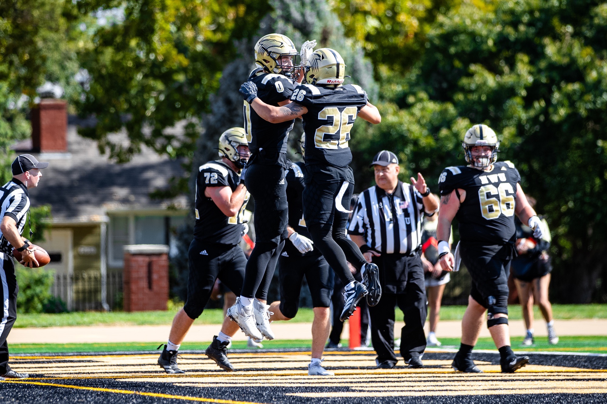 Joey McLaughlin & Samario Garcia jump in the air celebrating a touchdown