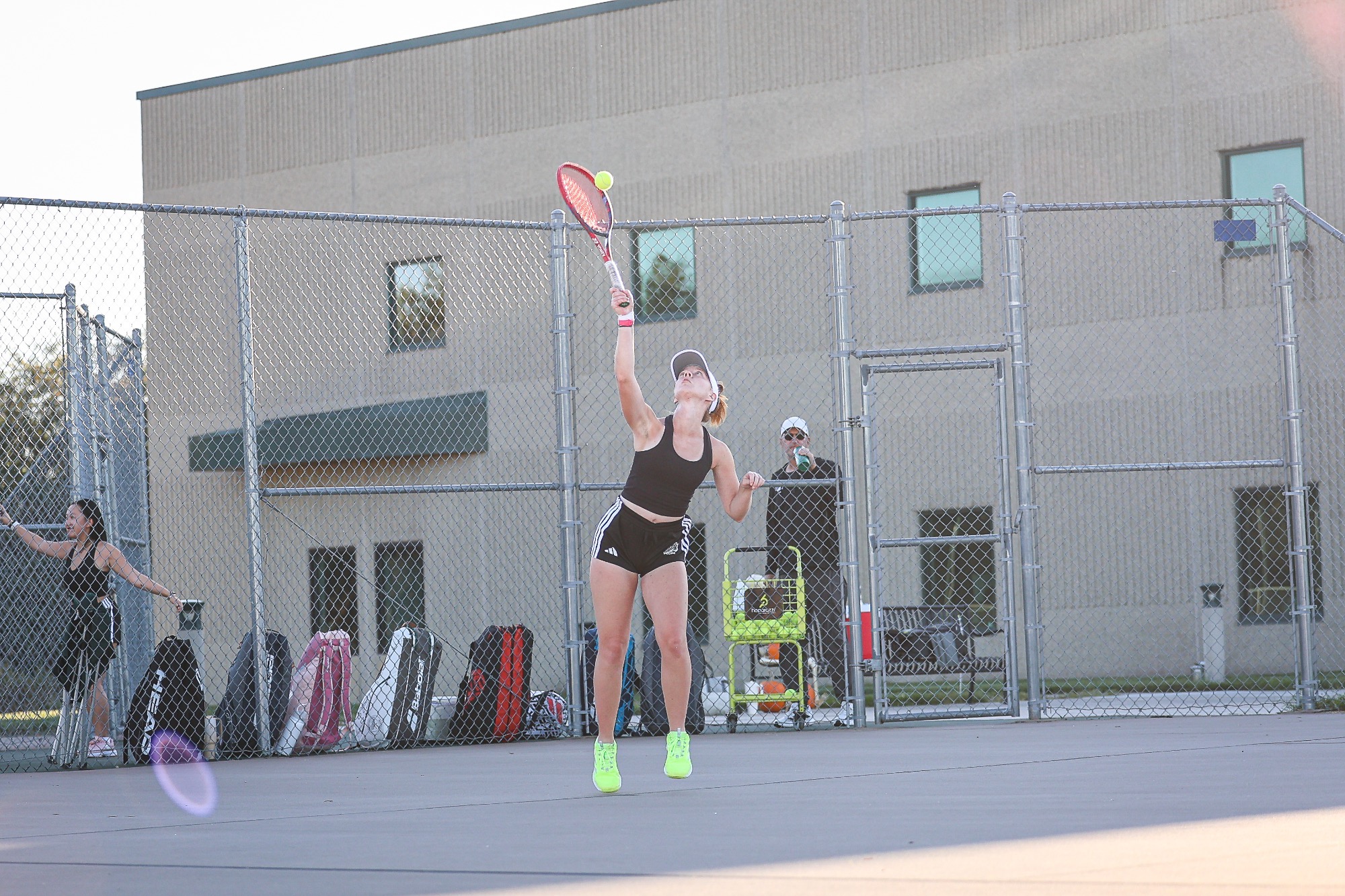Sylvia Kamradt tosses the tennis ball up to serve