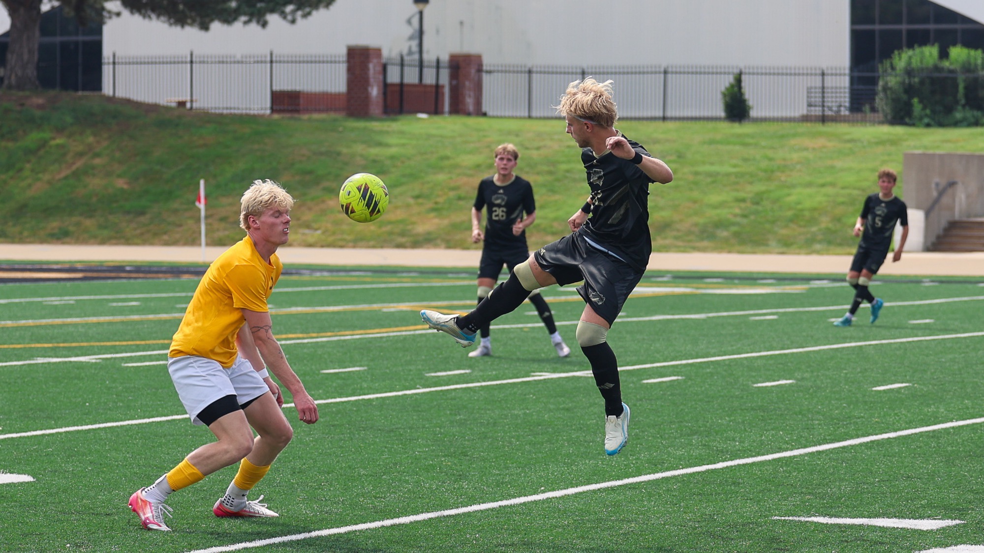 Wil Tobaben kicks his foot up to get the ball