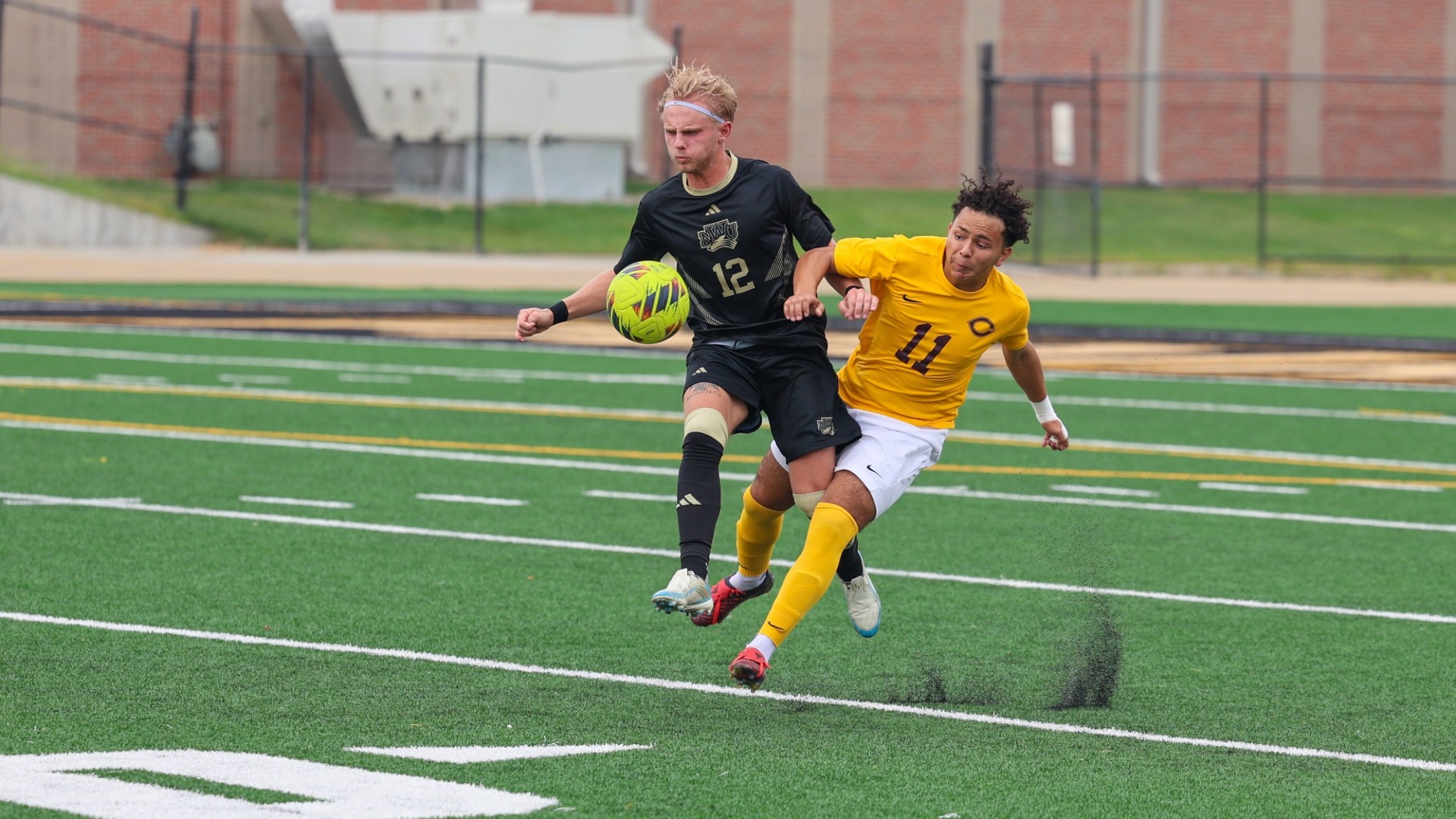 Wil Tobaben wins a ball against a defender in the air