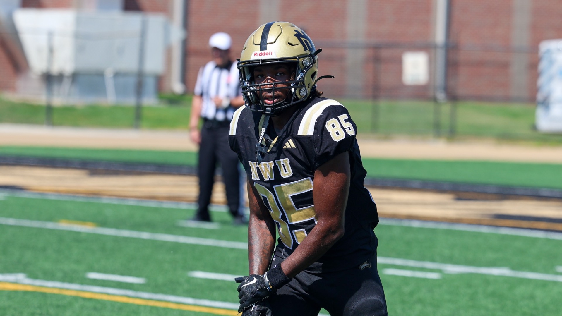 Jalen Pickens checks with the ref on the sideline to see if he is on the line.