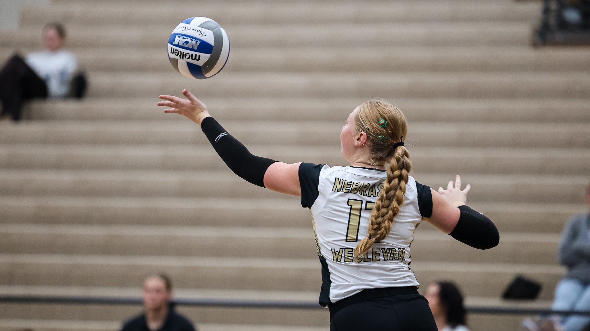 Jera Schuerman tosses the ball up to serve