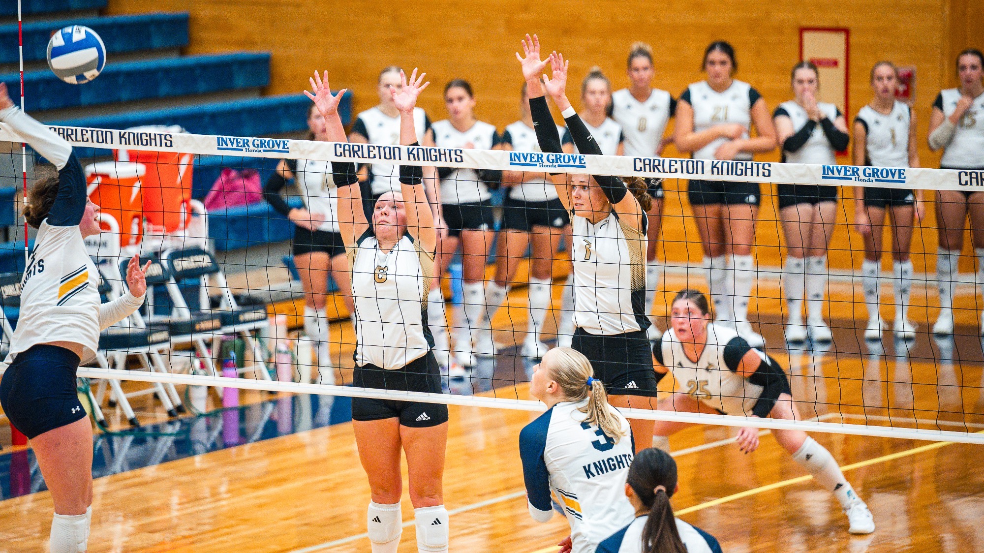 Elecea Saathoff & Ella Foote go up for a block against Carleton