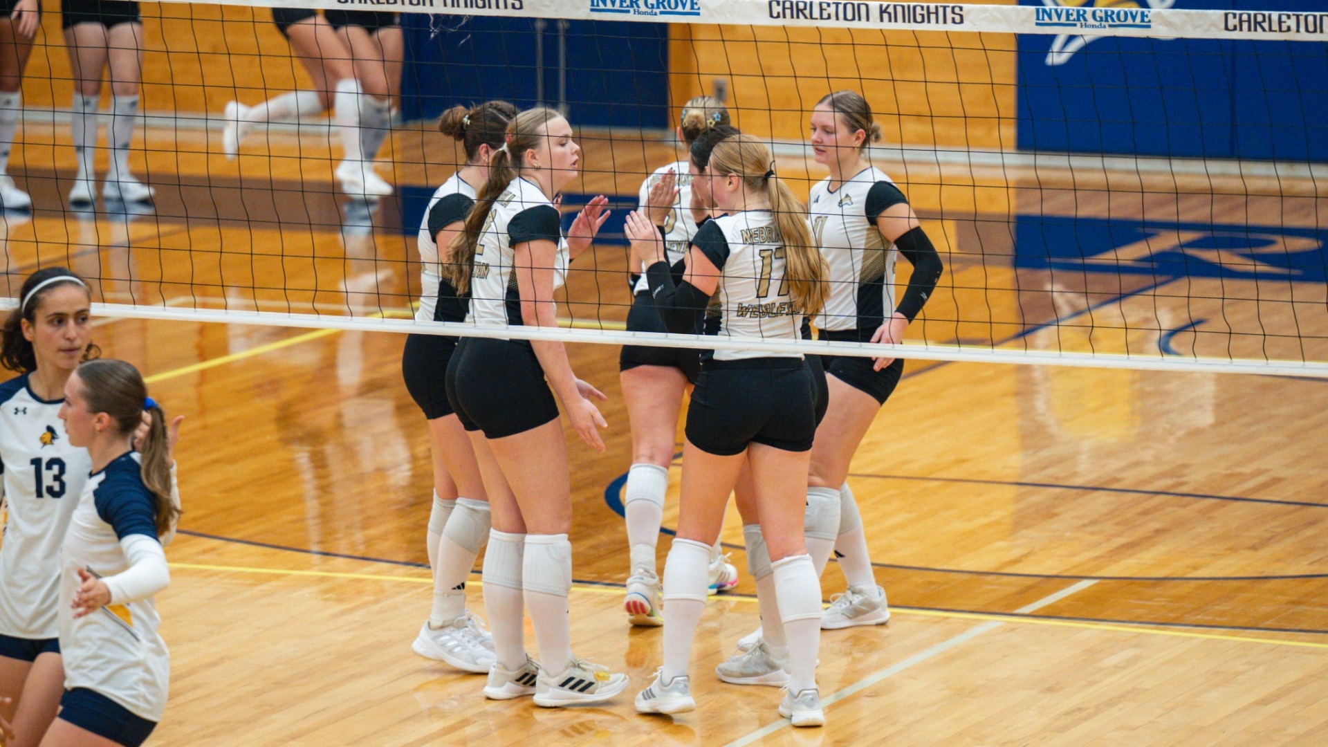 NWU Volleyball joins together in a huddle