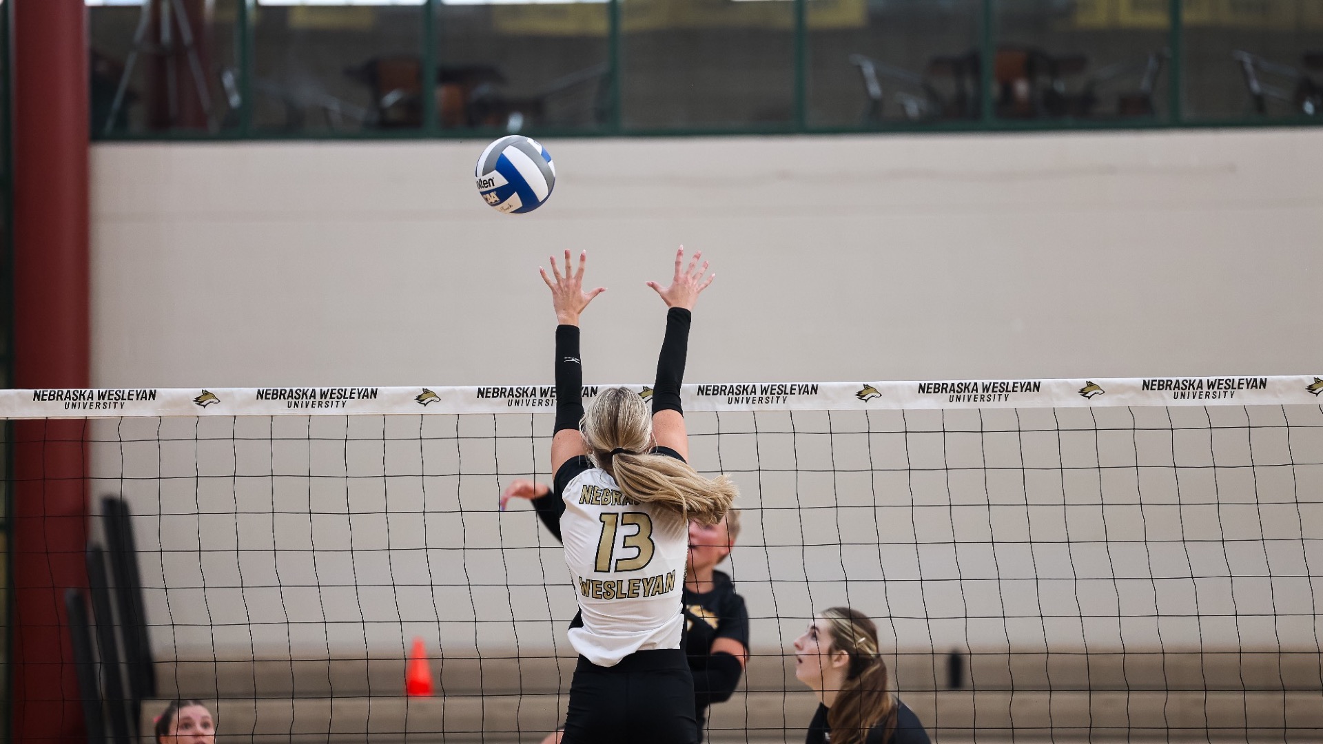 Ava Stone goes up high for a block