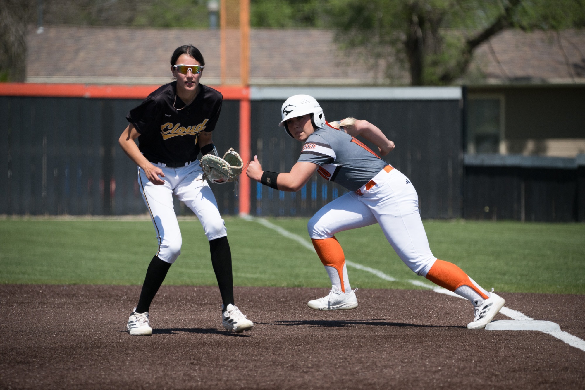 Neosho County Softball Player leaves first base as Cloud County Softball Infield looks to field the ball 2026
