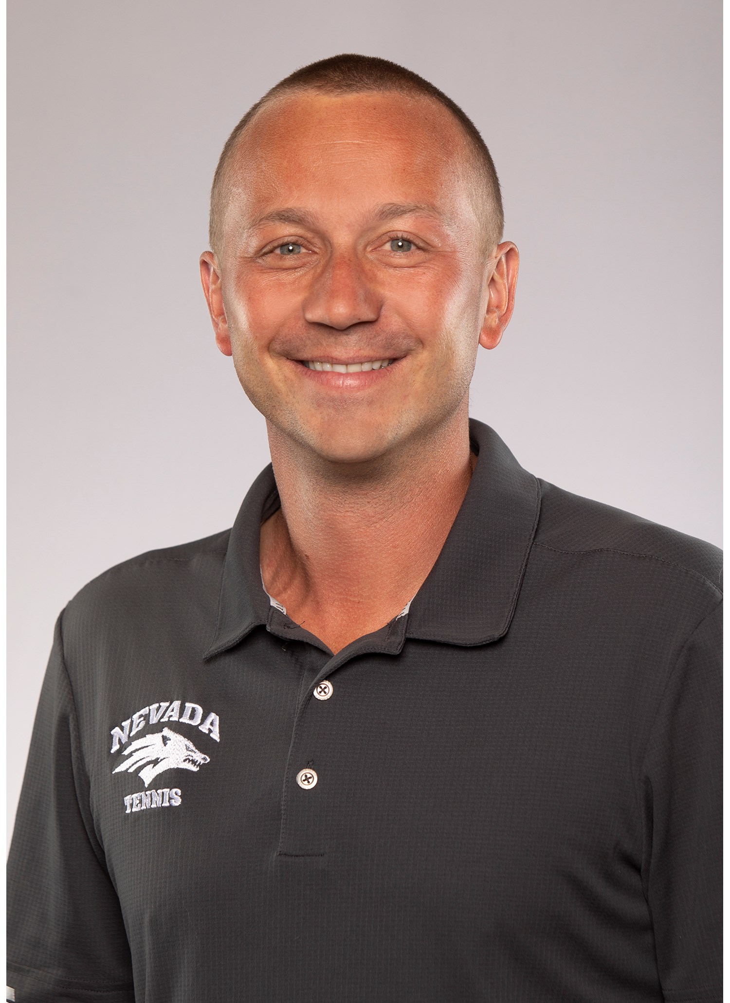 Head women's tennis coach Guillaume Tonelli head shot.