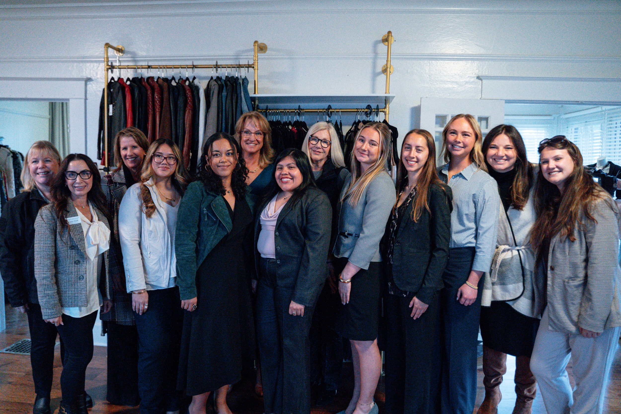 Group of women in business attire taking a group photo