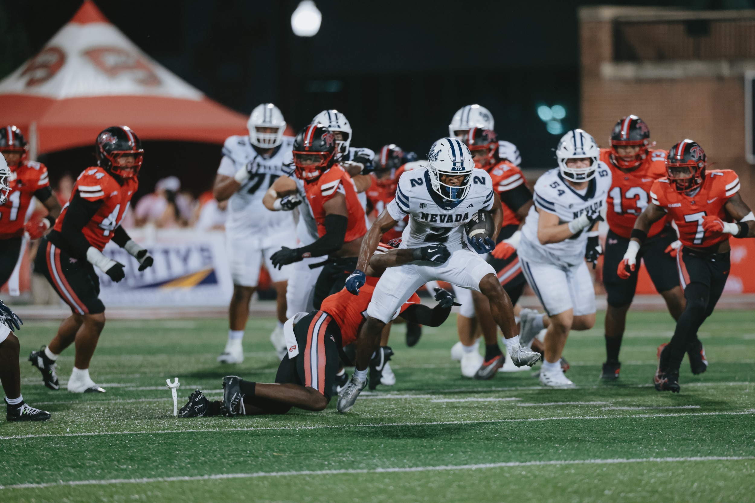 Herschel Turner carries the ball while a defender attempts to tackle
