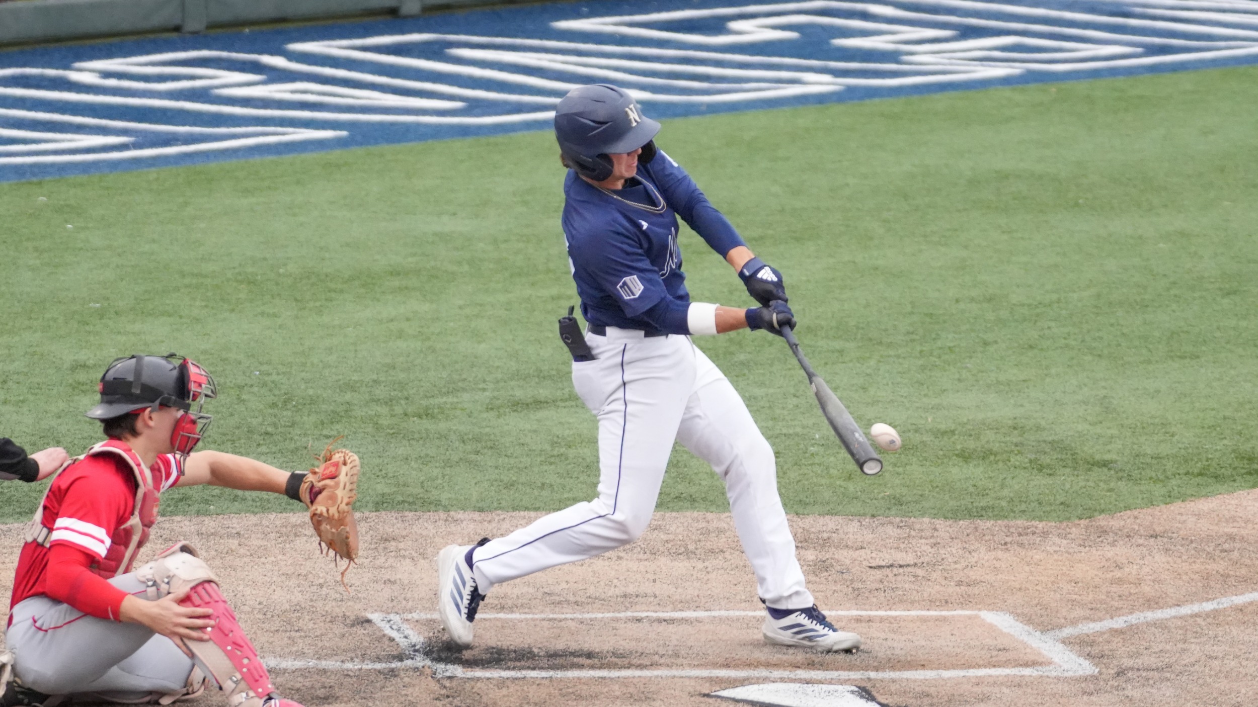 Jake Harvey swings and makes contact with a baseball