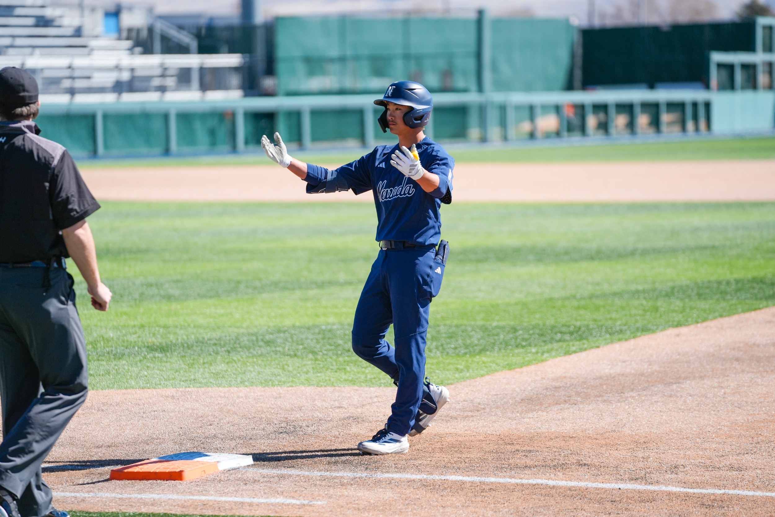 Lee Matsuzaki in a navy uniform standing on first base