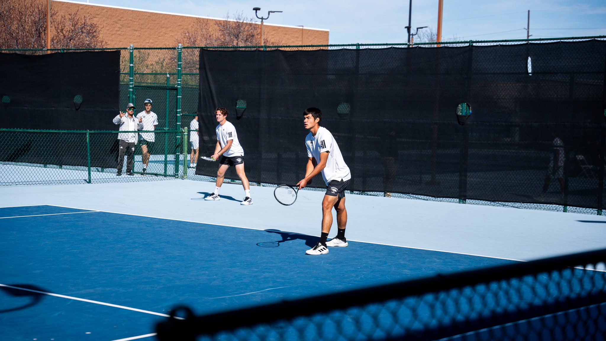 Nevada men's tennis doubles tandem waiting for a serve