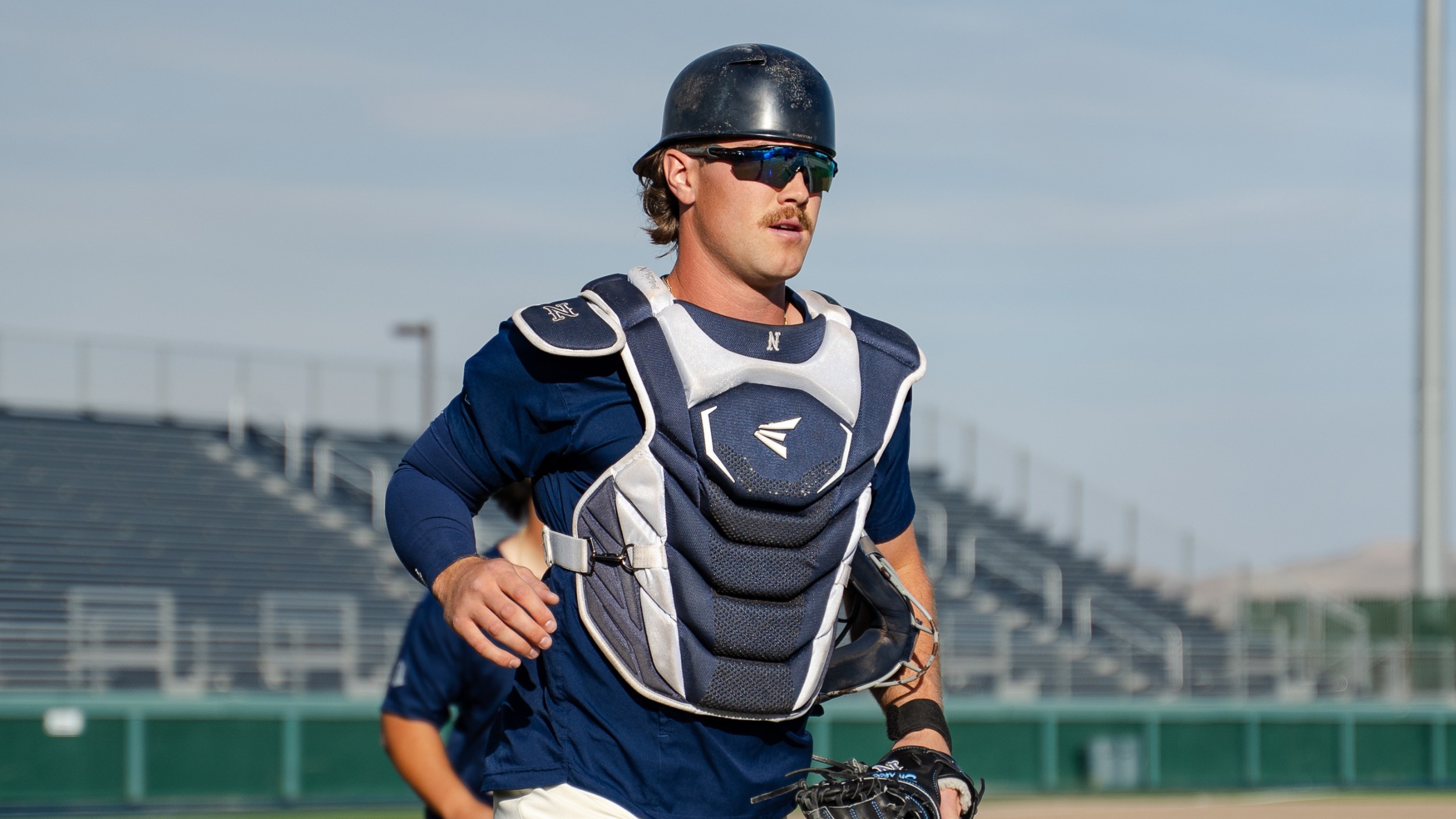 Nate Snakenborg in catchers gear running off the field pregame