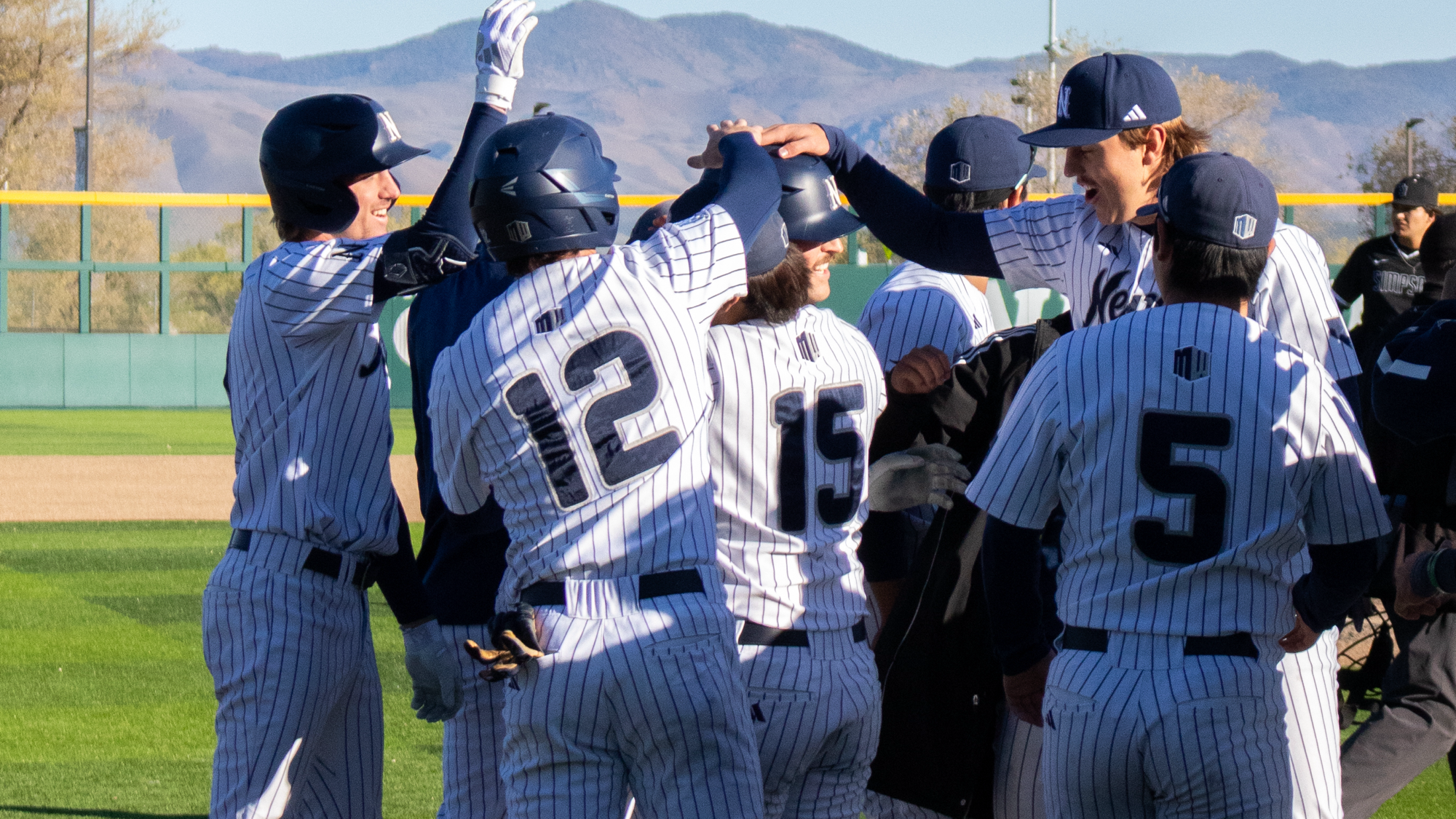 Nevada team celebrates a home run at home plate