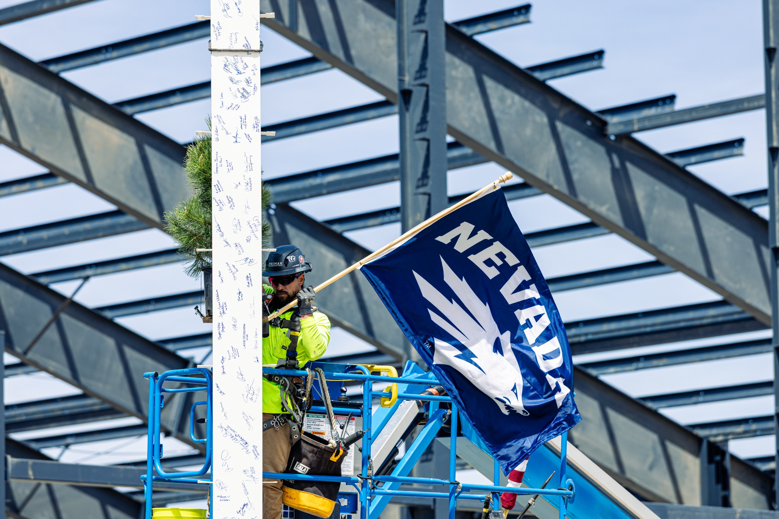 A navy blue flag with the Nevada Athletics logo flies from the beam