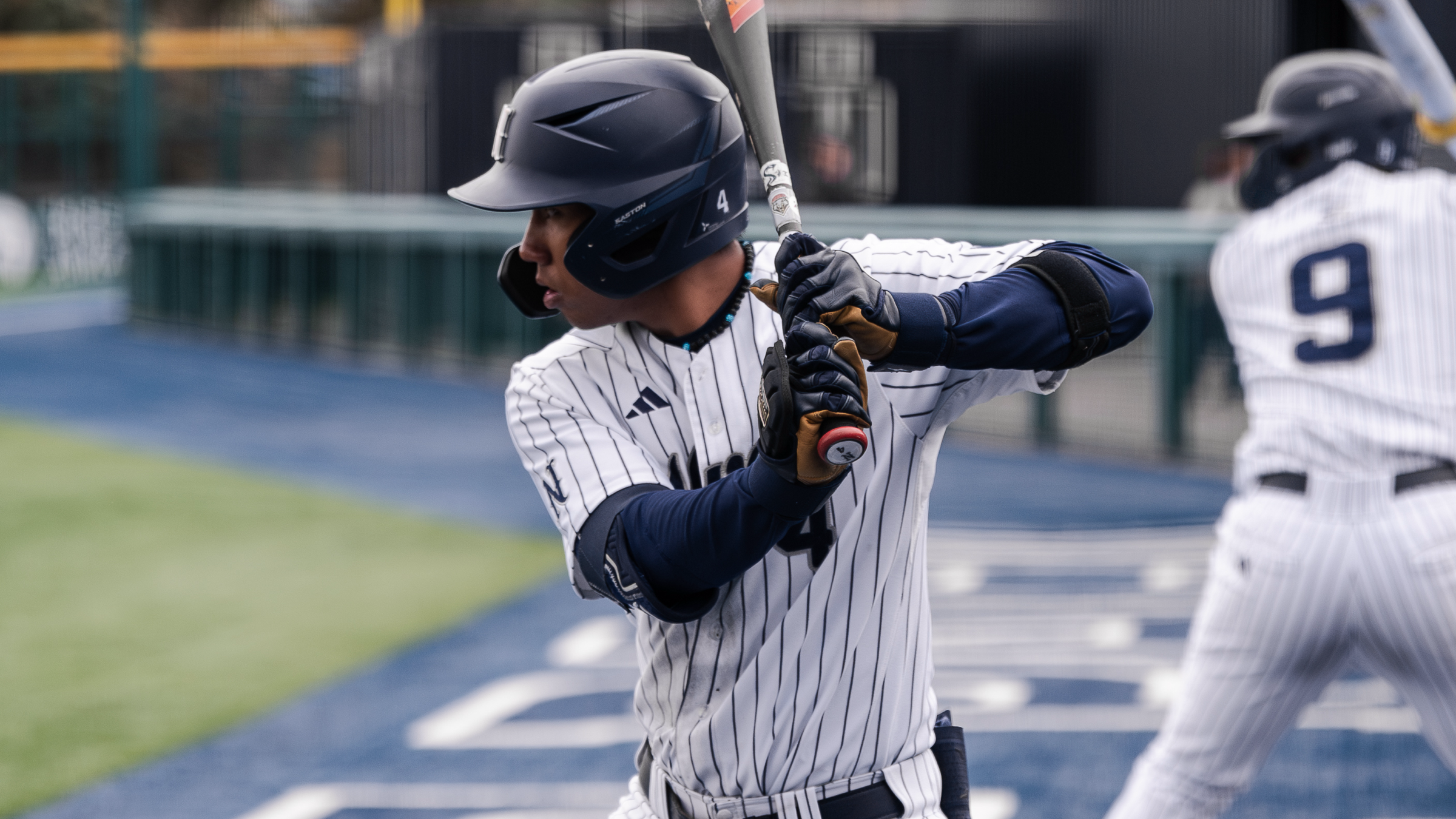 Rominic Quiban in a batting stance in the on-deck circle