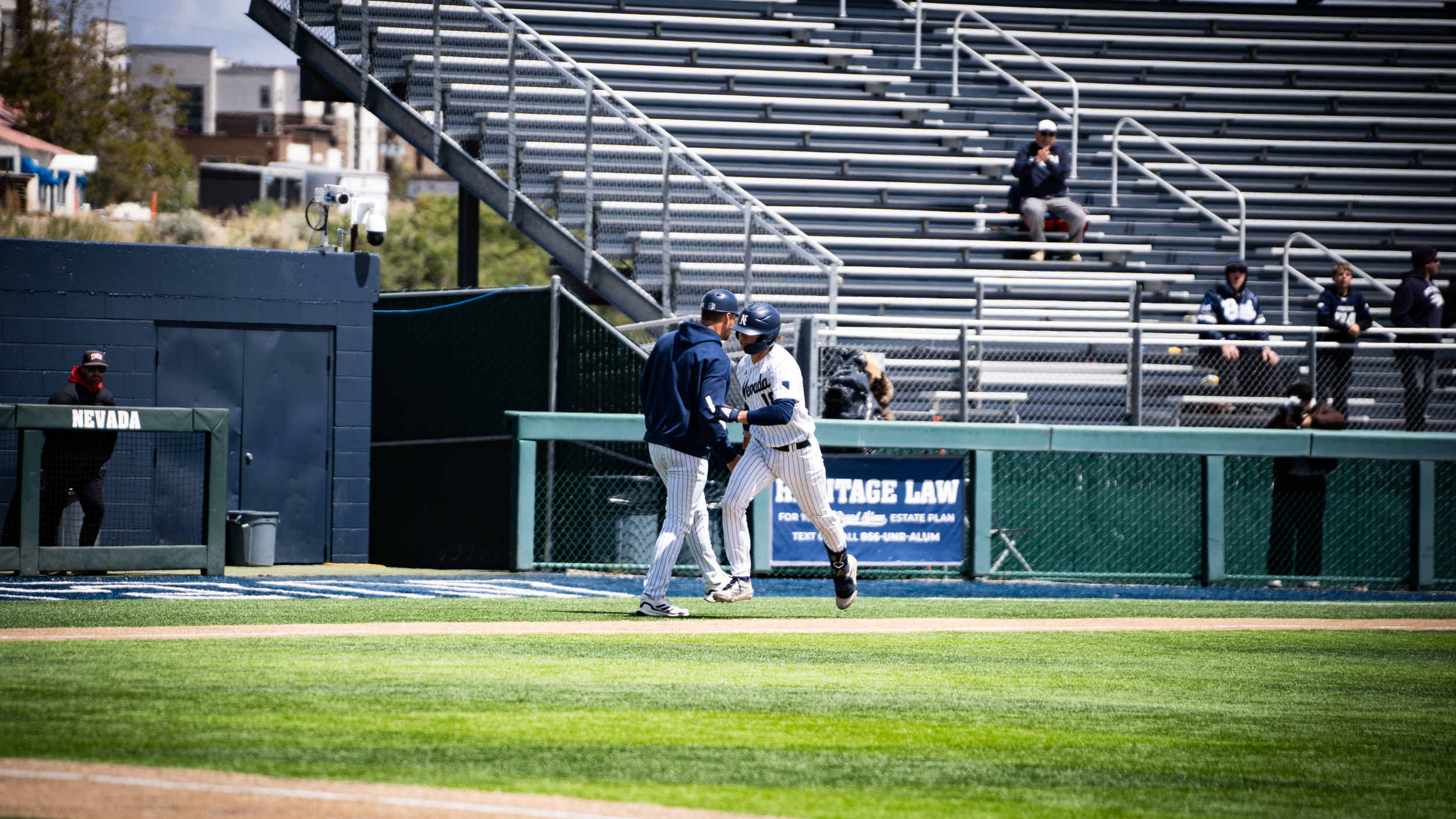 Jake Harvey shakes hands with Jordan Getzelman rounding third on a home run trot