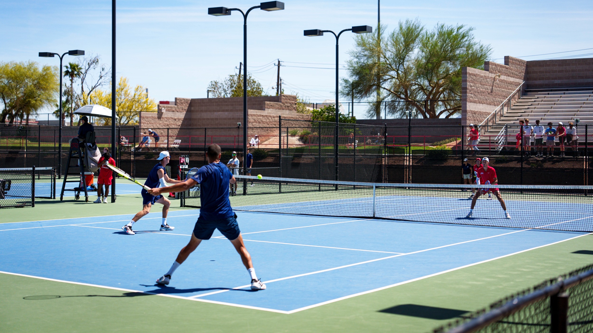 Nevada Men's Tennis and UNLV playing a doubles match