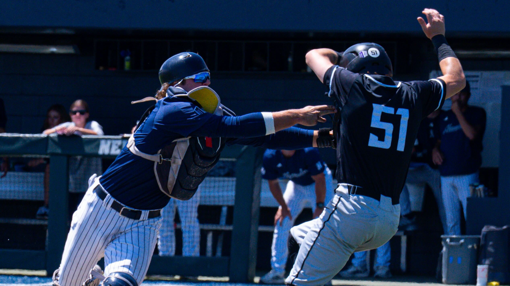 Jake Harvey tags a runner out at home plate