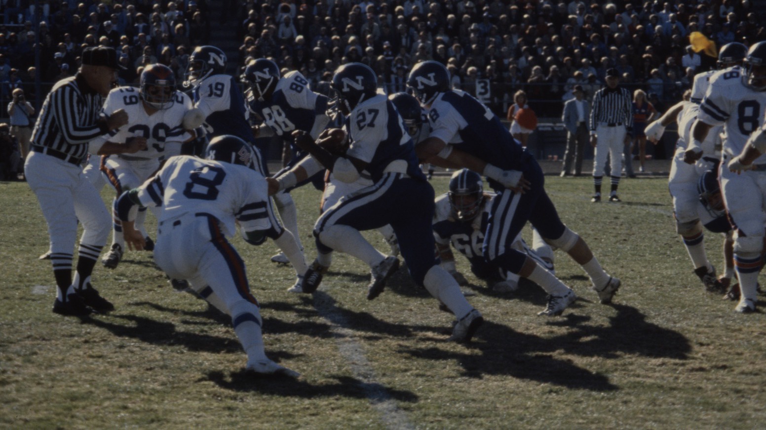 Frank Hawkins carries the ball through the Boise State defense in a football game