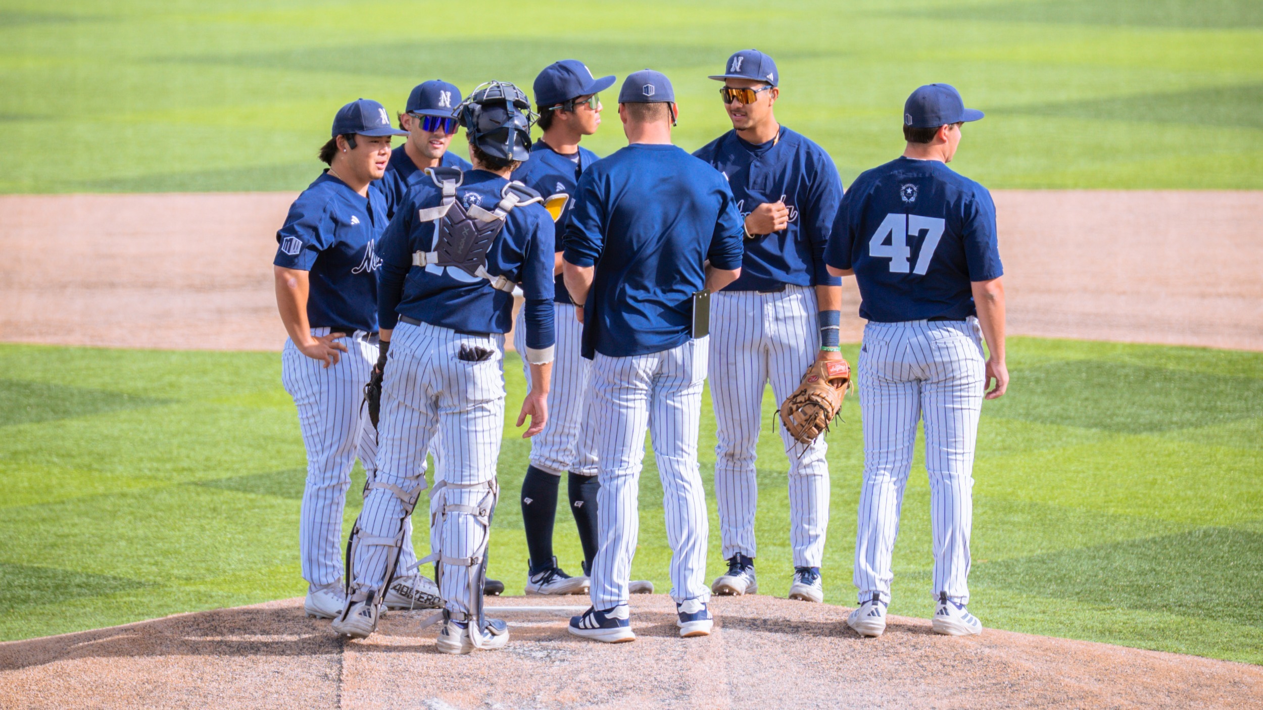 Nevada baseball players huddled at the pitcher's mound