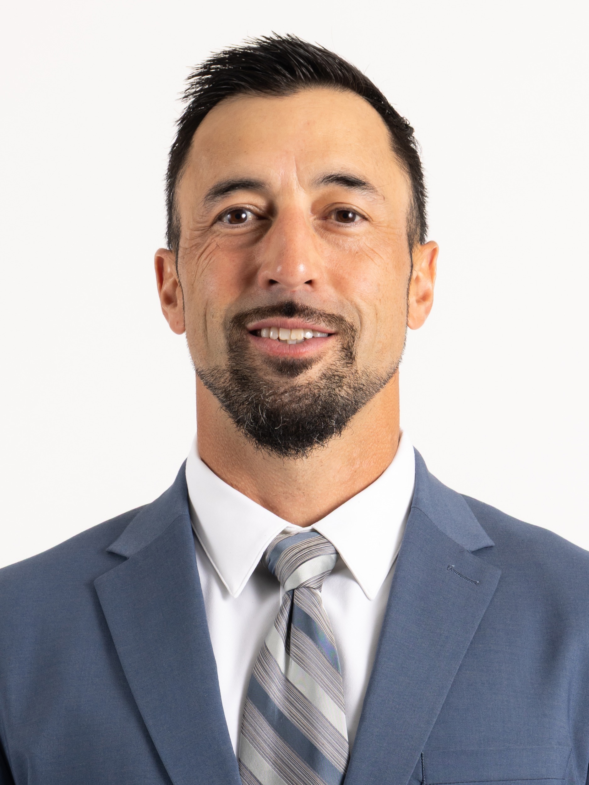 Headshot of man with dark hair and goatee