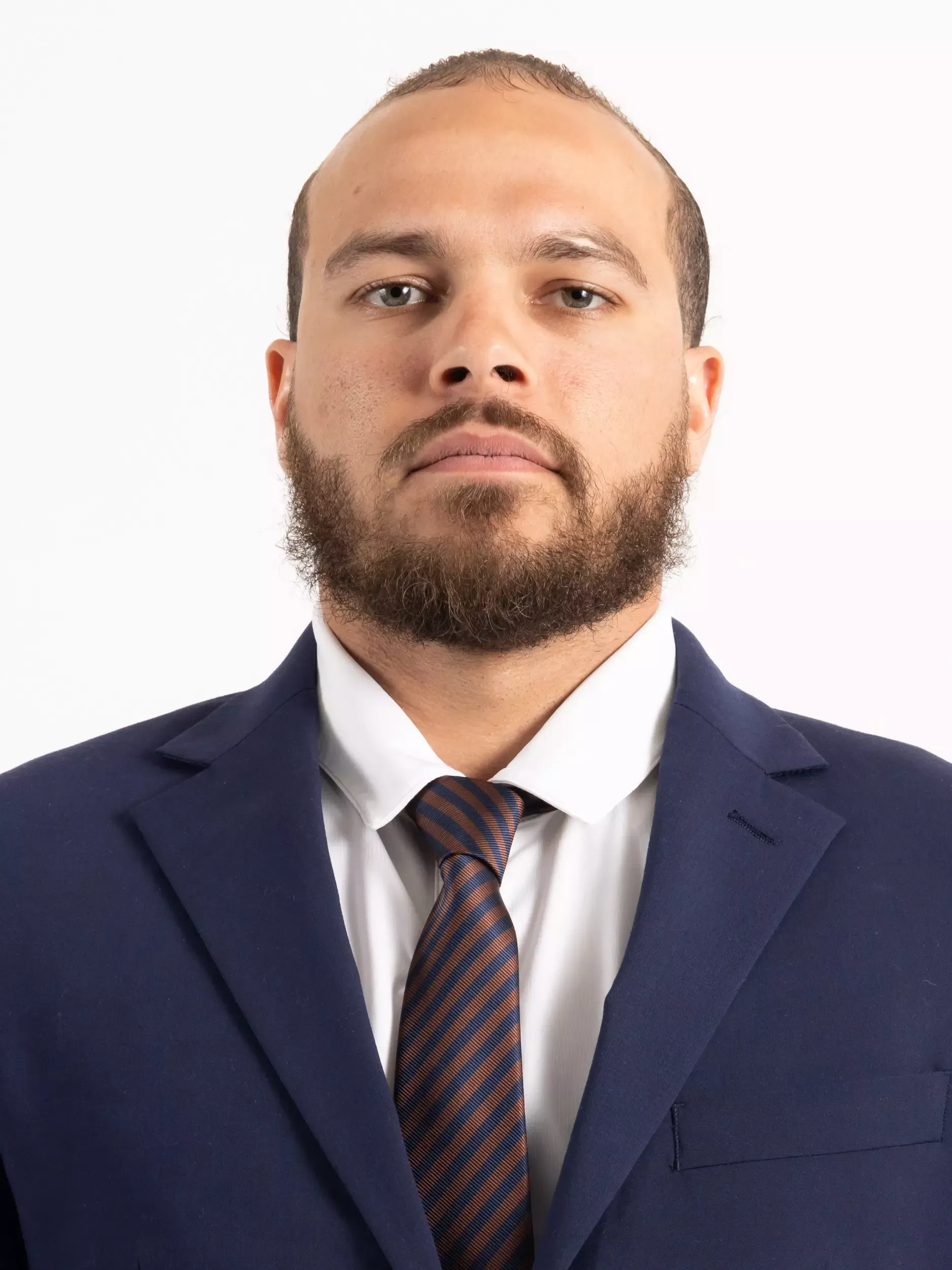 Carlos Cottrell headshot in coat and tie