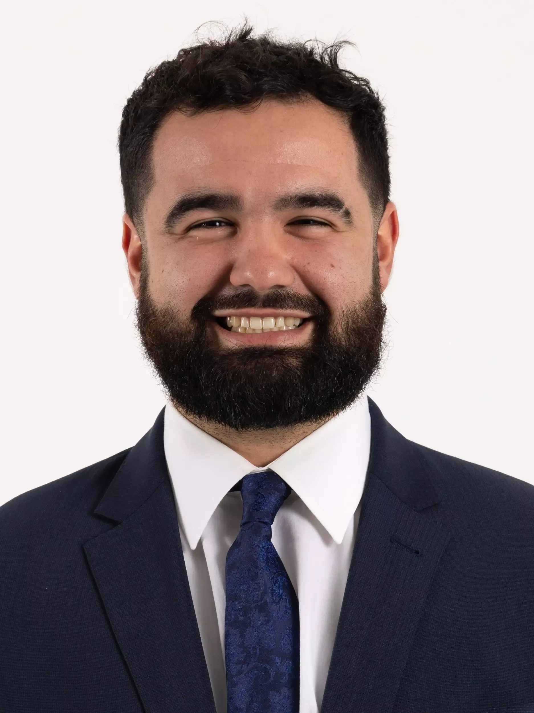 Dakota Harman headshot in coat and tie