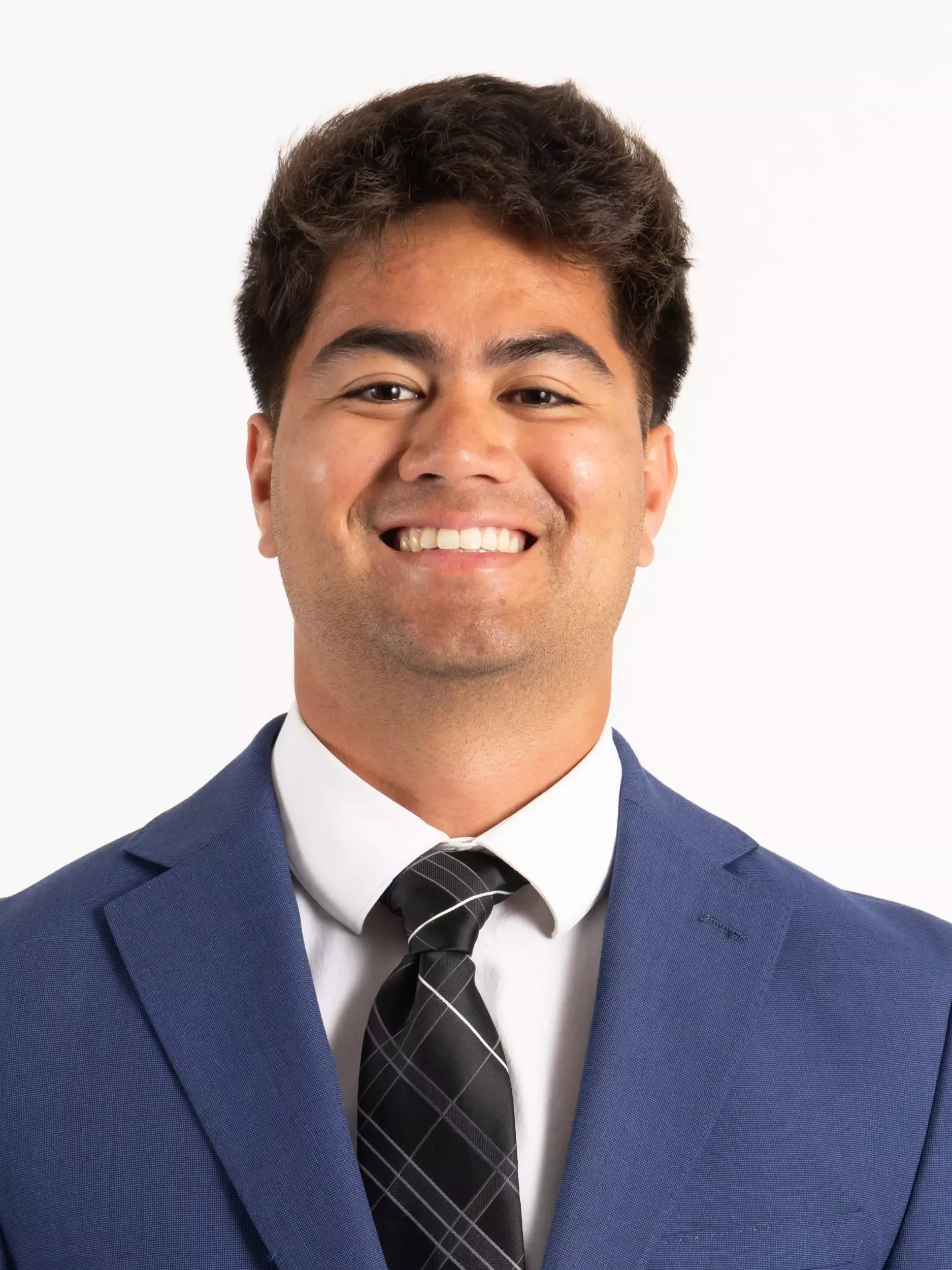 Kia'i Keone headshot in coat and tie