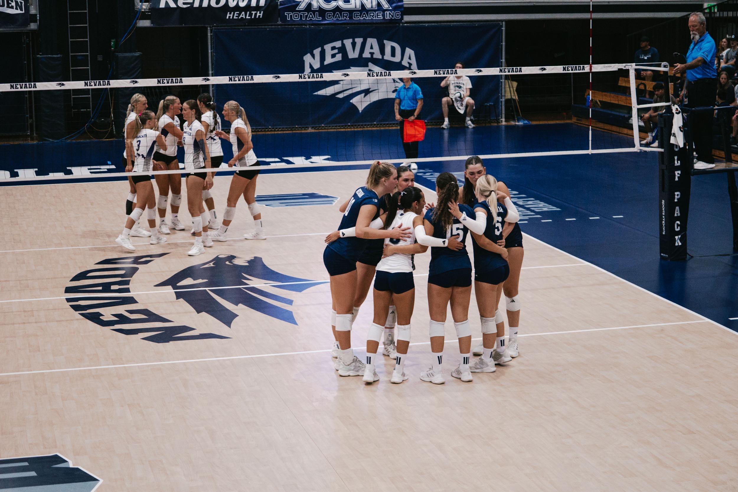 Nevada volleyball team huddled before a serve