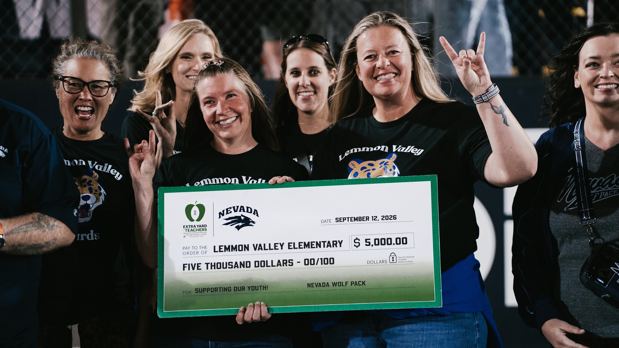 A group of women holding an oversized check addressed to Lemmon Valley Elementary School for $5,000