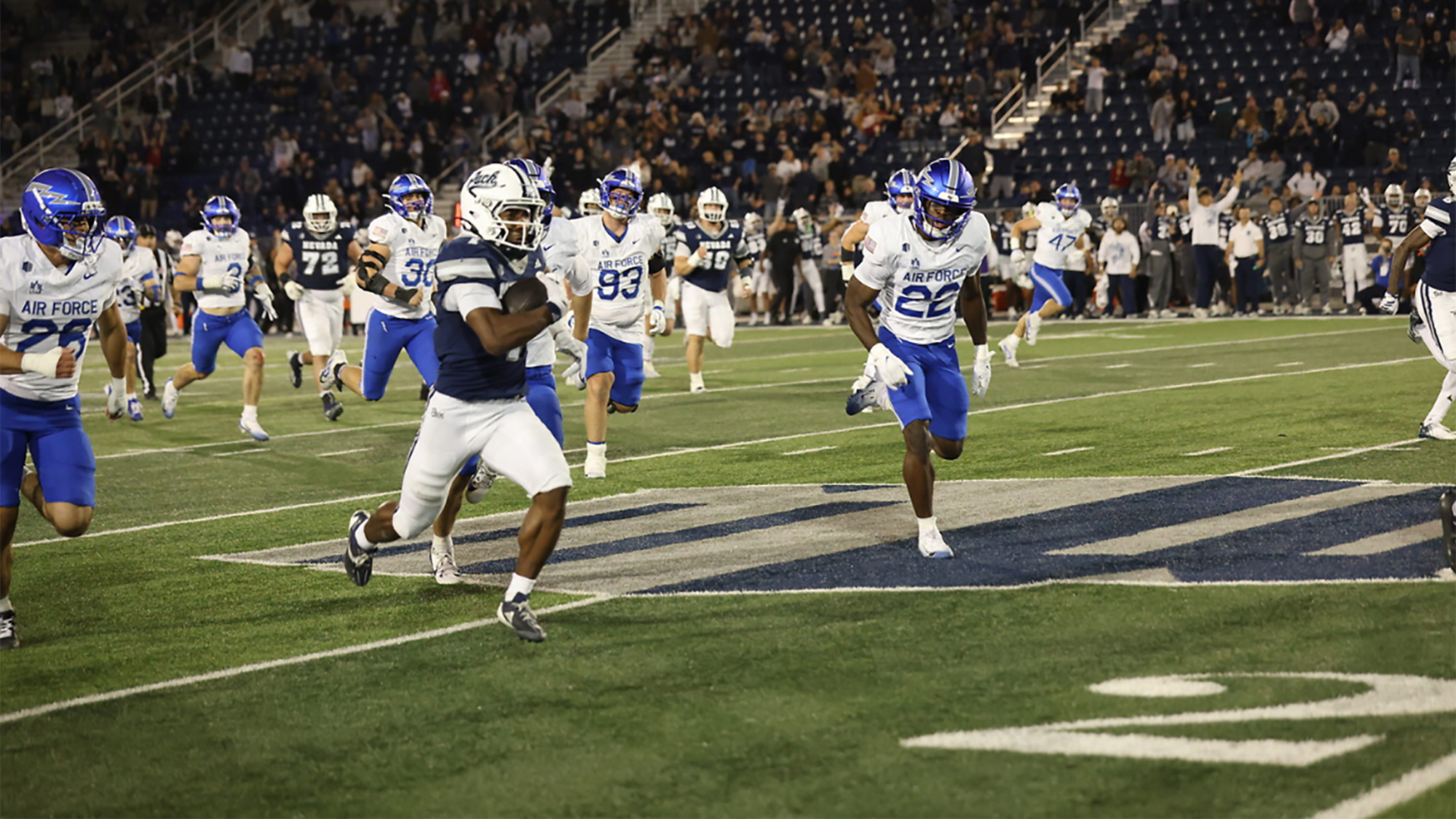 Herschel Turner running to the end zone chased by multiple defenders