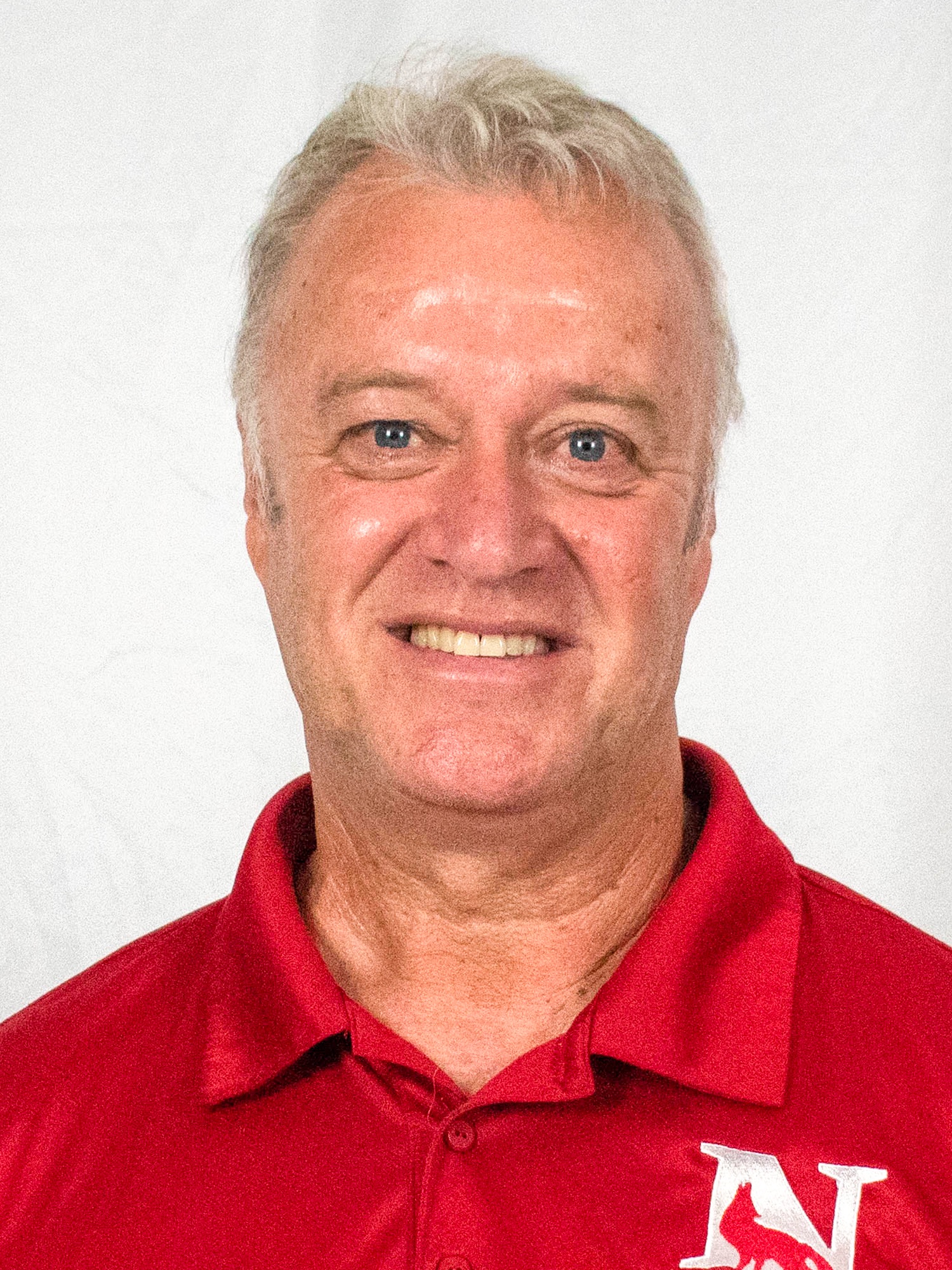 Scott Hutchinson headshot in a red polo with a white background