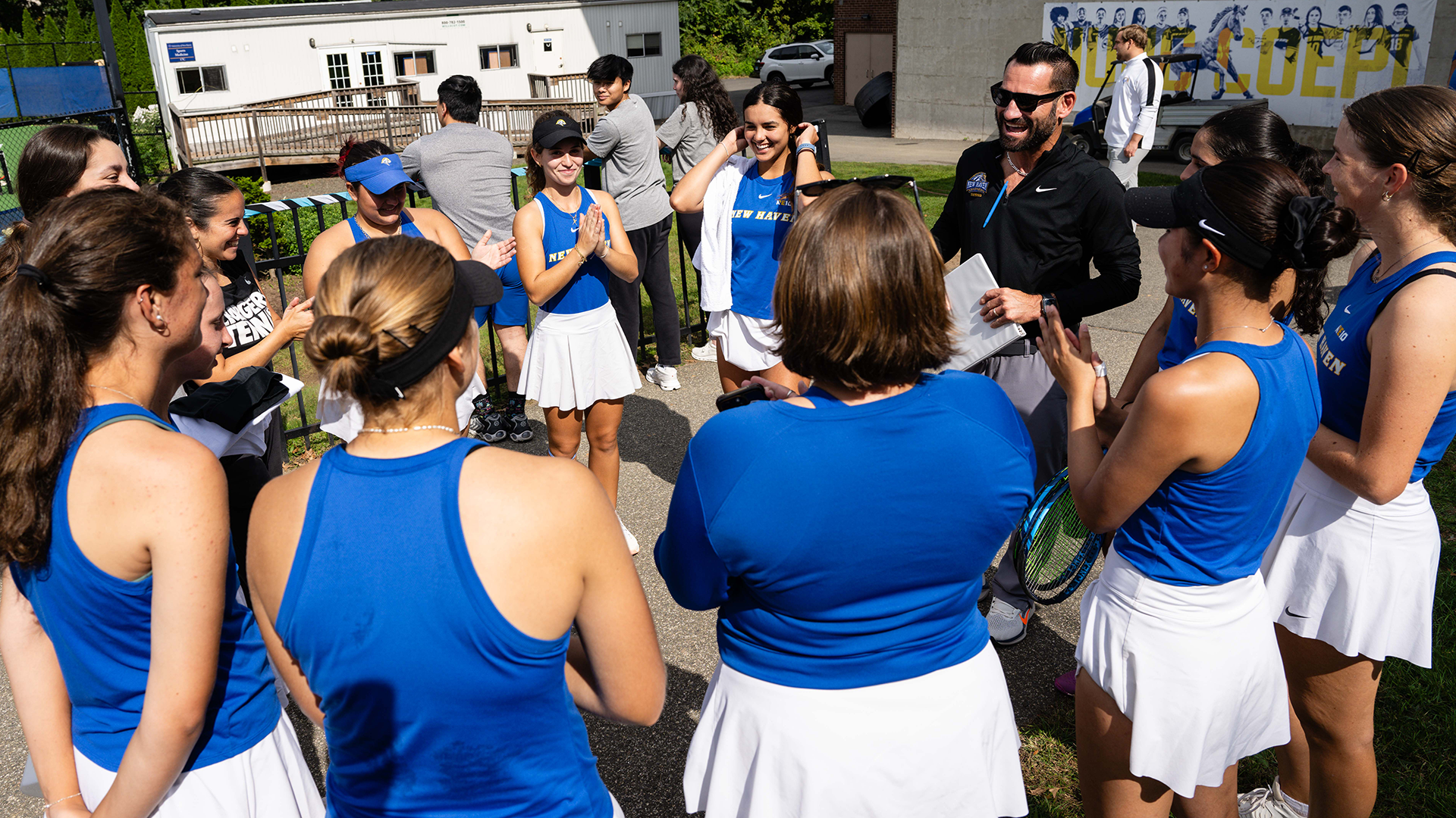 Women's Tennis Team Huddle Photo