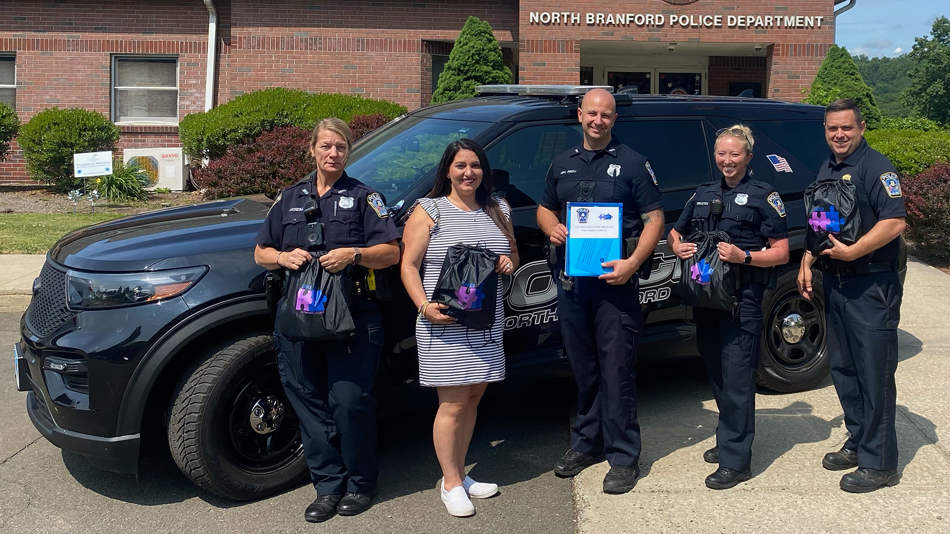Dance Team Head Coach Ashley McClain with Members of the North Branford Police Department