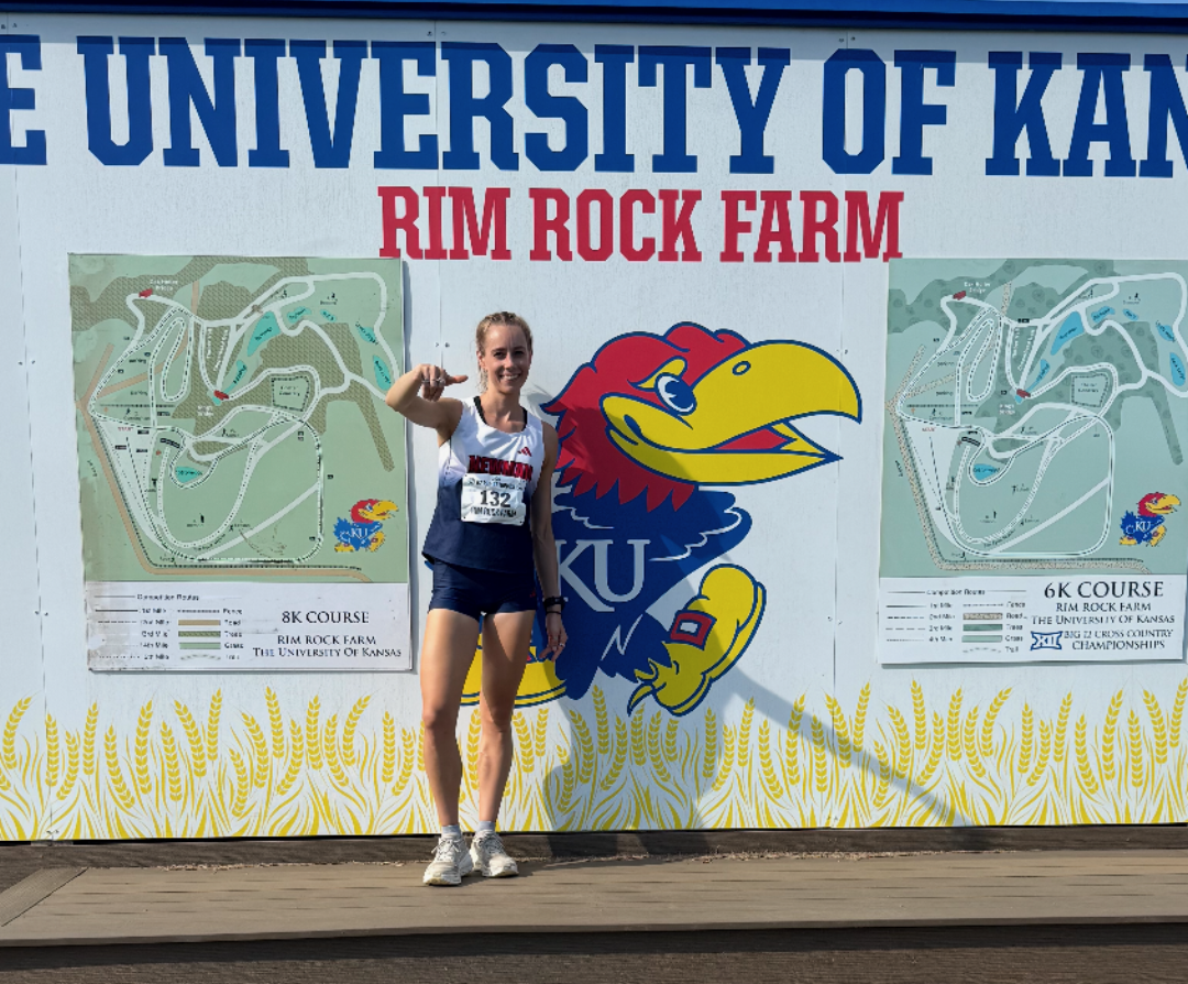 Katie Hughes at the Rim Rock Farm sign