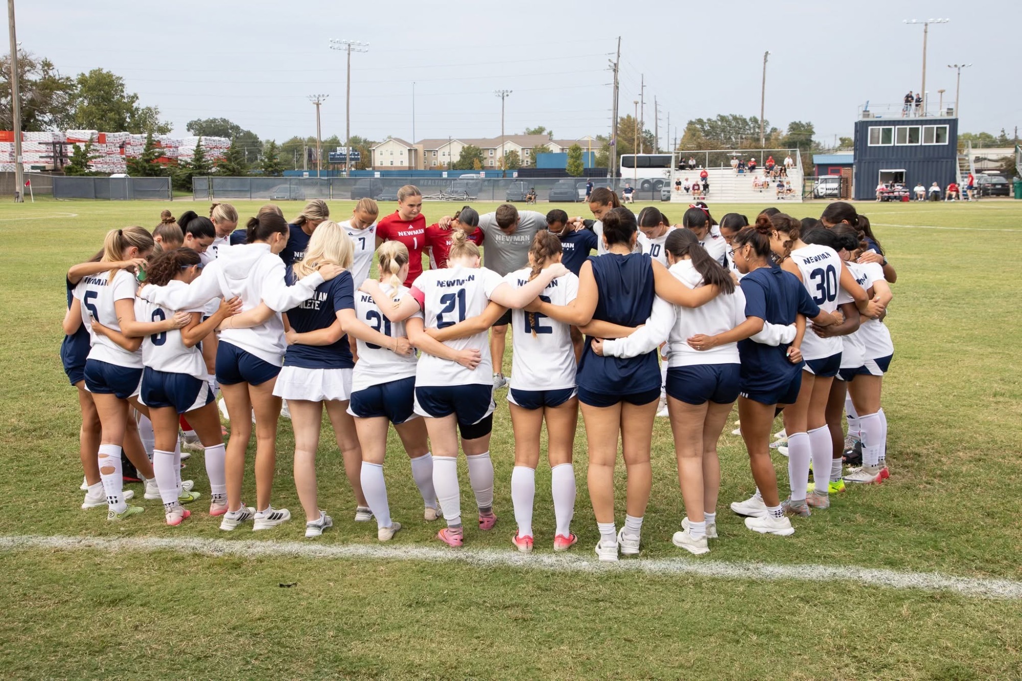 Newman Jets in a huddle