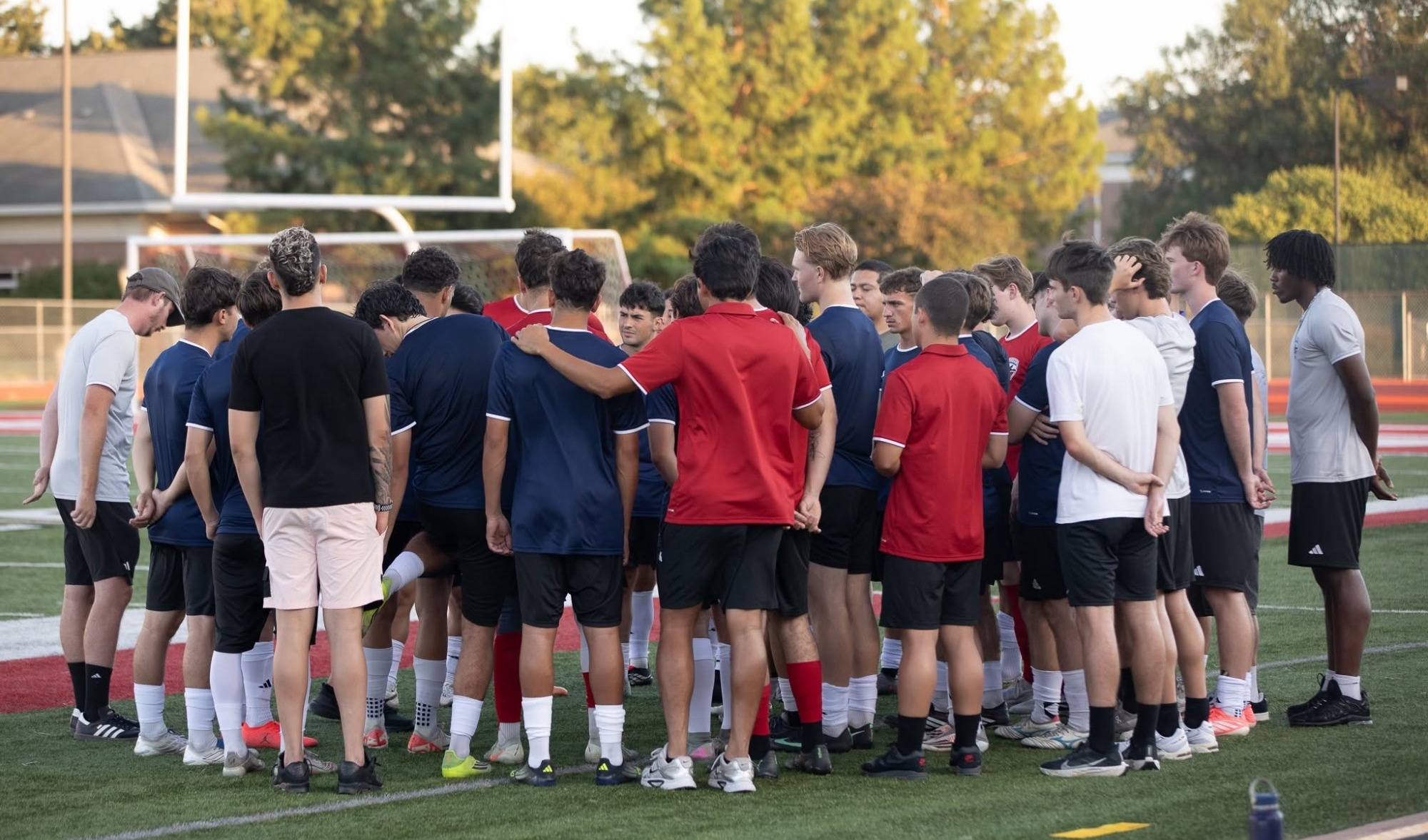 Men's Soccer huddles before competoition
