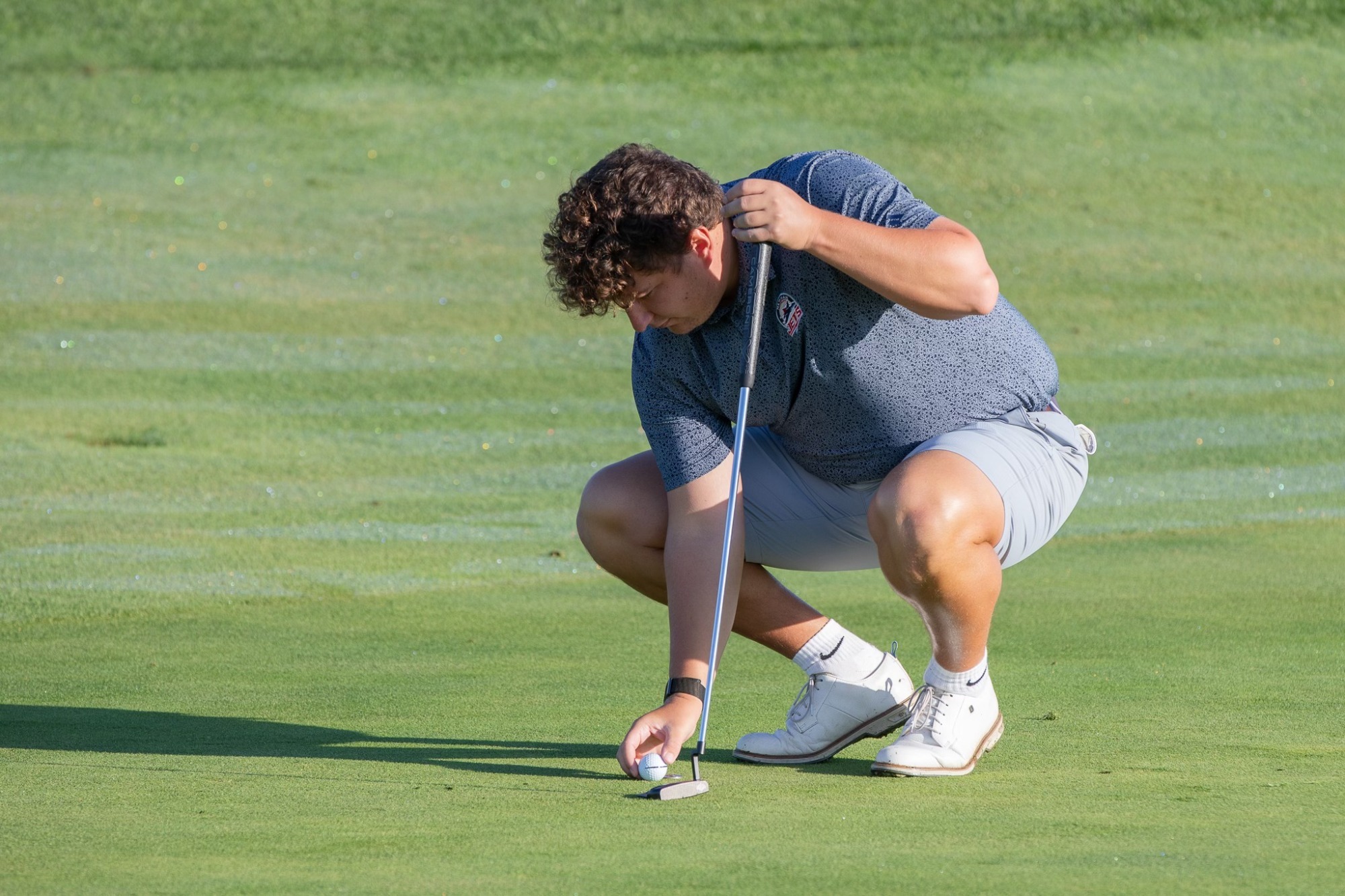 Golfer Lines up Putt