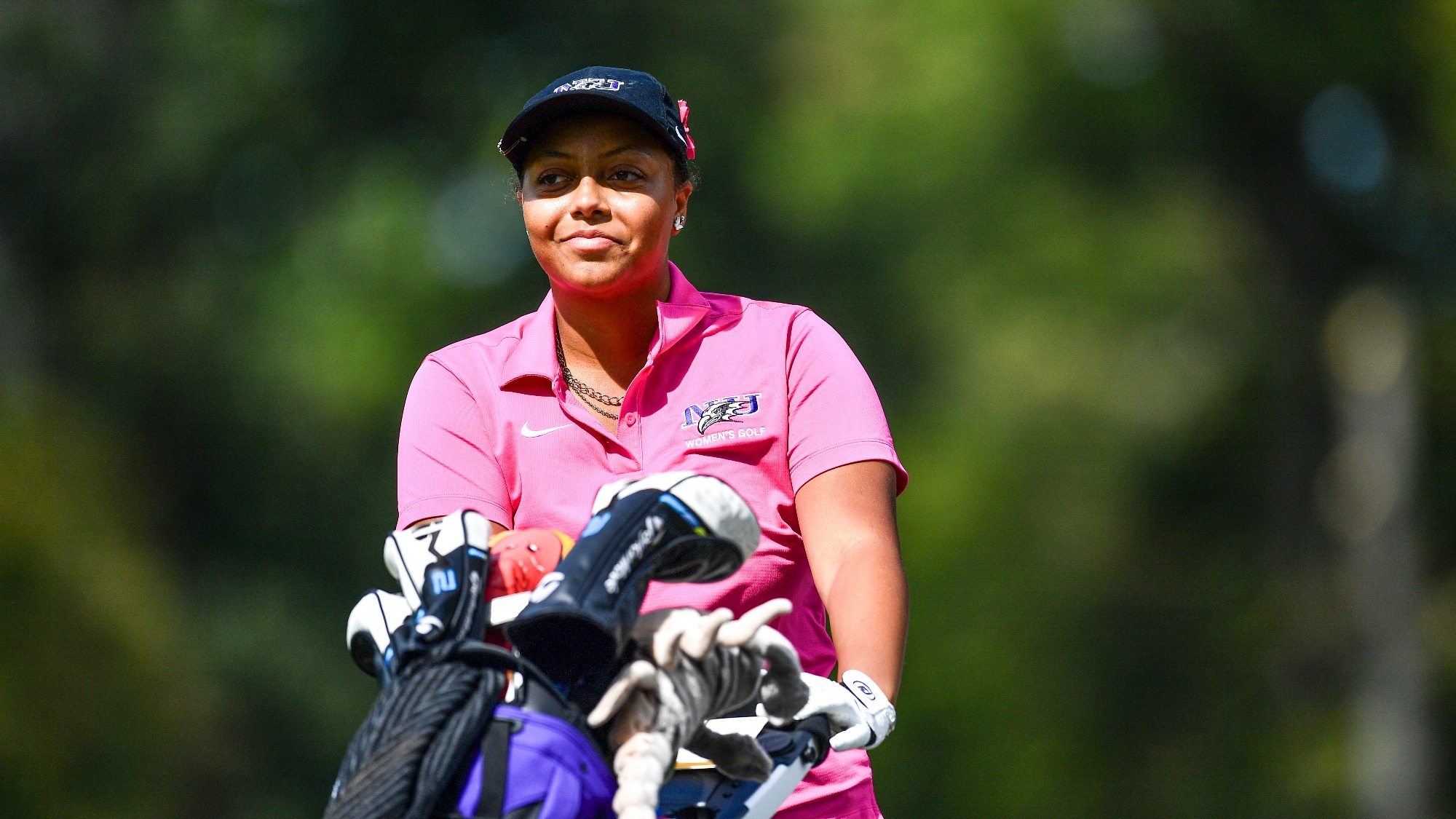 Peyton Bell pushes her golf bag at Ninth Annual Roseann Schwartz