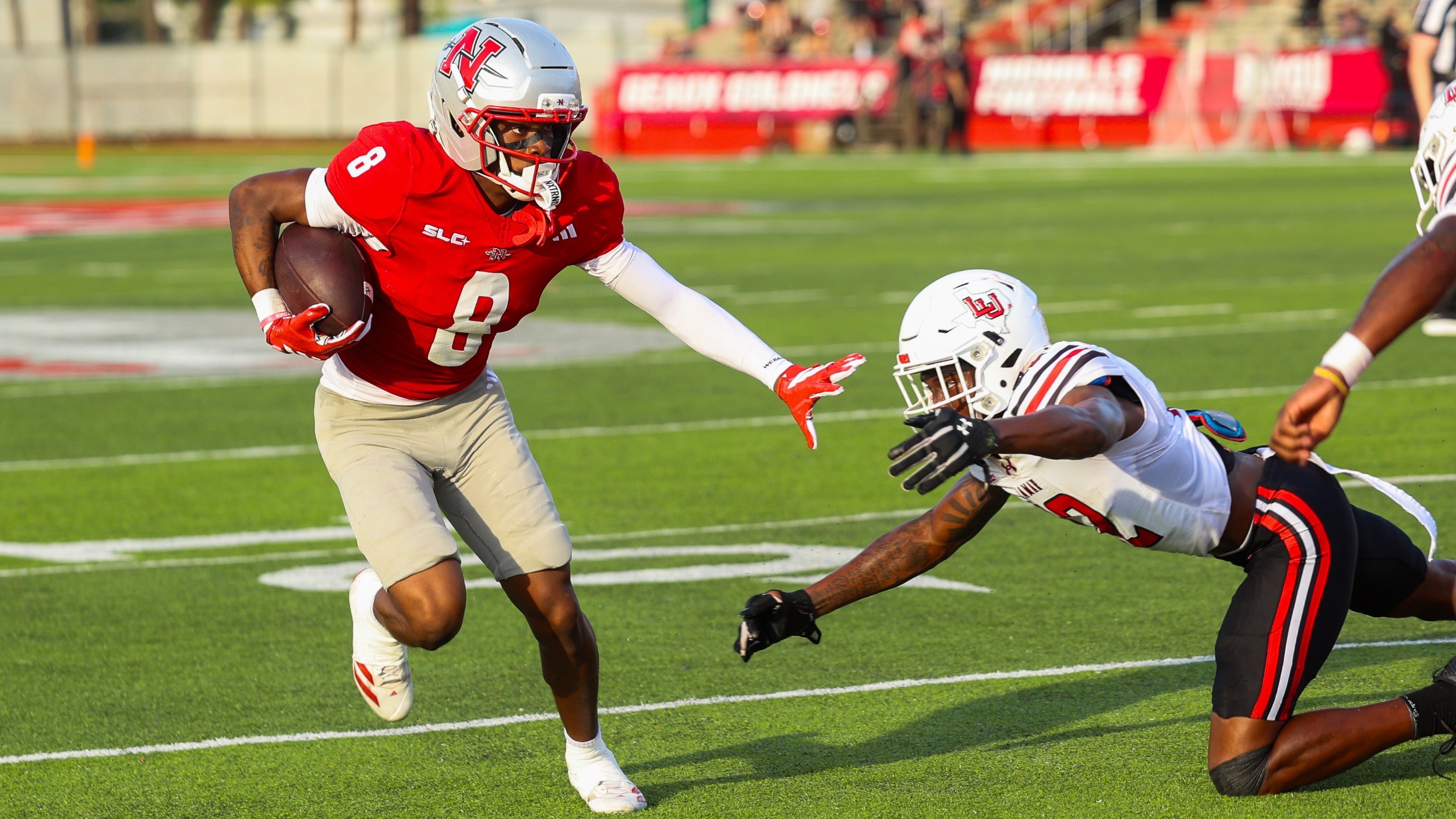Ellis Stewart evades a Lamar defender after catching a pass
